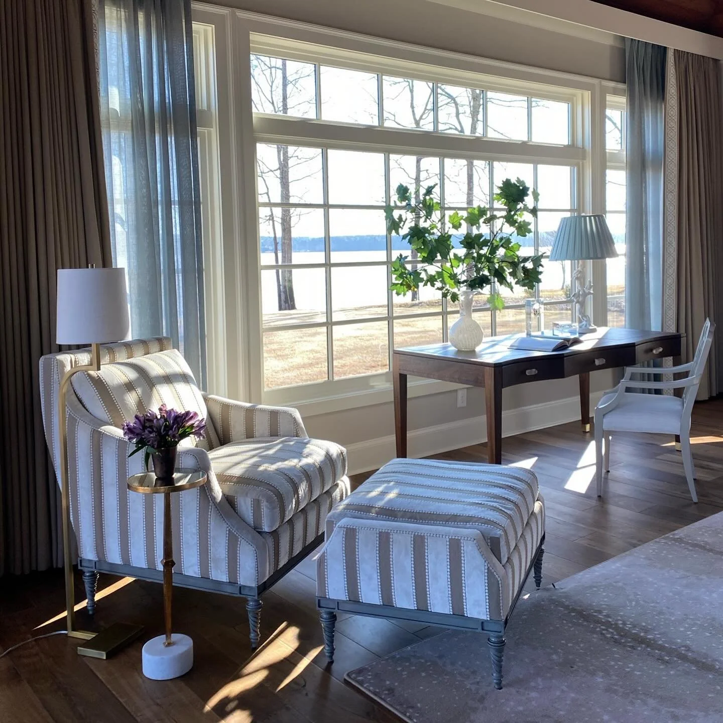 Such beautiful morning light off this area in a Primary Bedroom. Swipe for the details of the soft blue sheer playing off the lake water, to the details and textures of the chair and rug.  #flashbackfriday

#abid #lakeliving #luxurylifestyle #bedroom