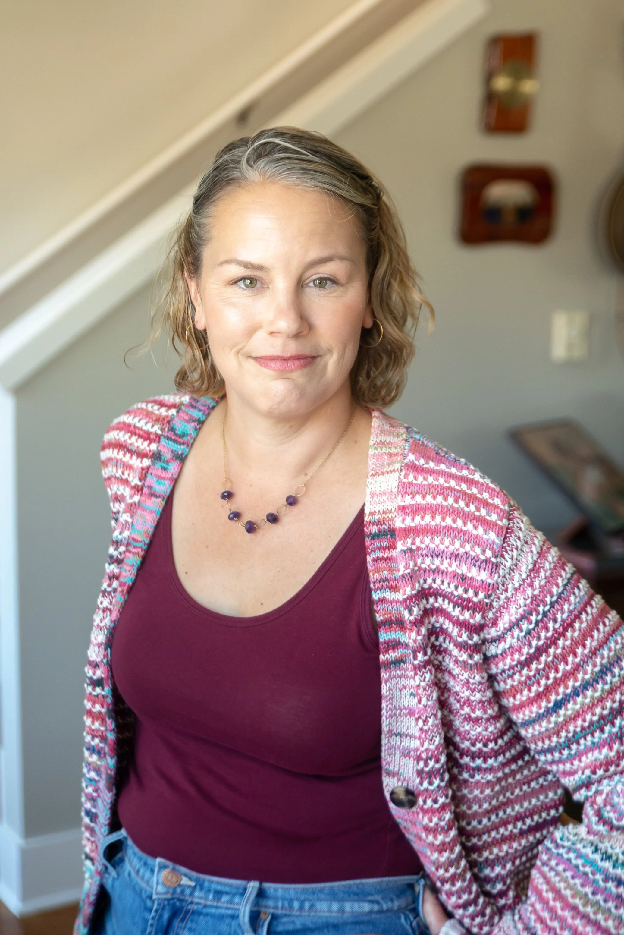 Portrait of Meghan Stevenson in a striped knit cardigan