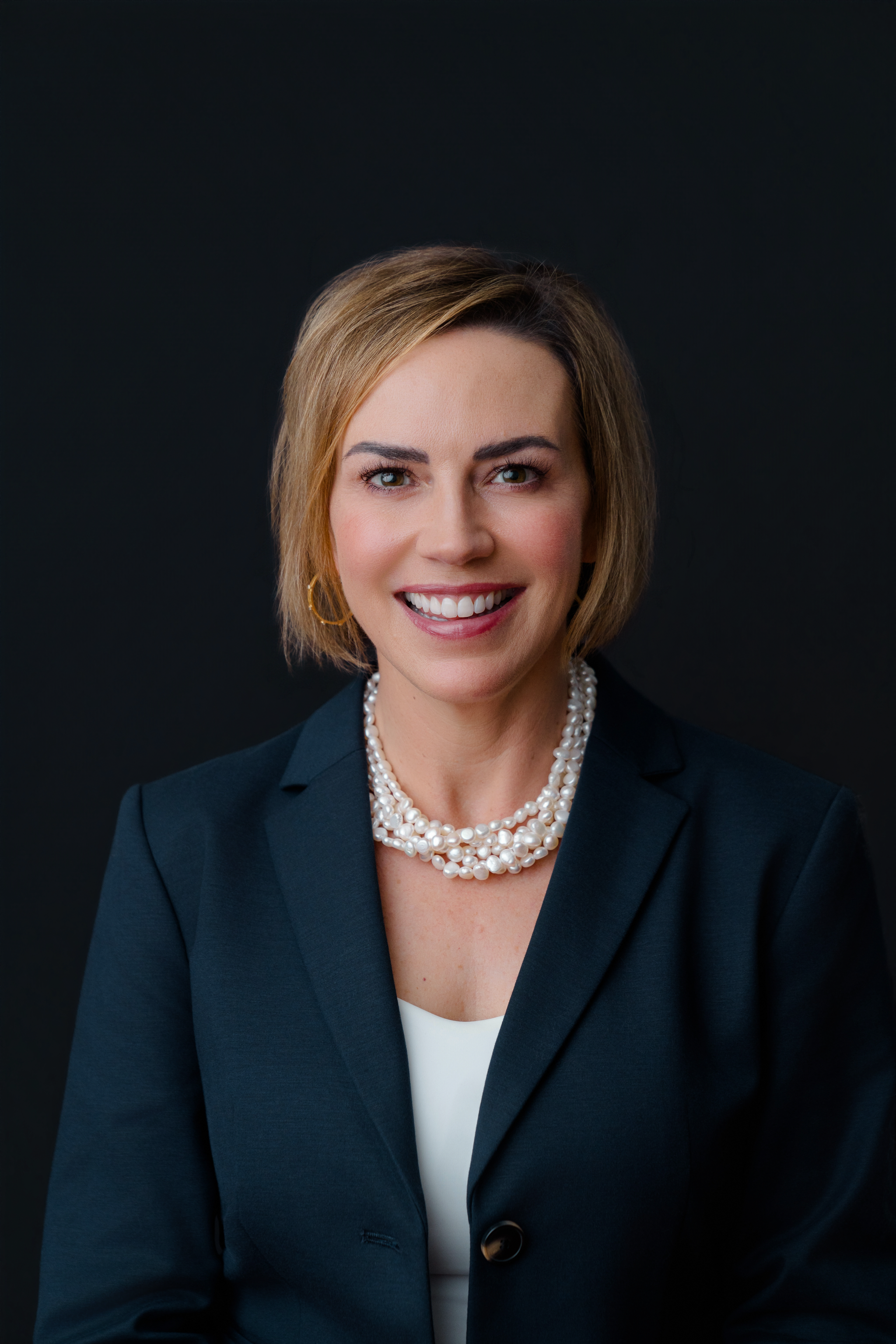 woman in black blazer and black background
