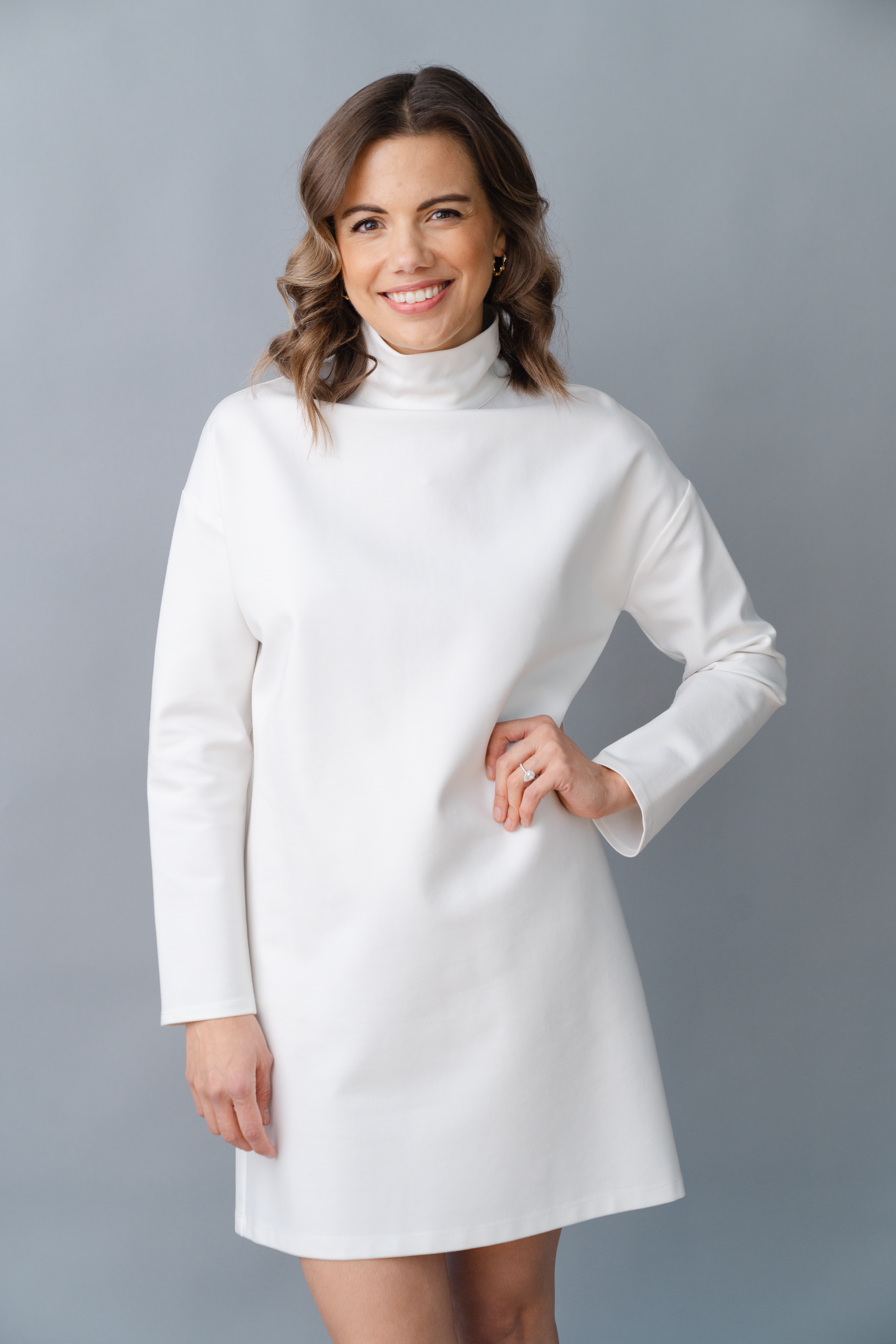 woman in white against a gray background