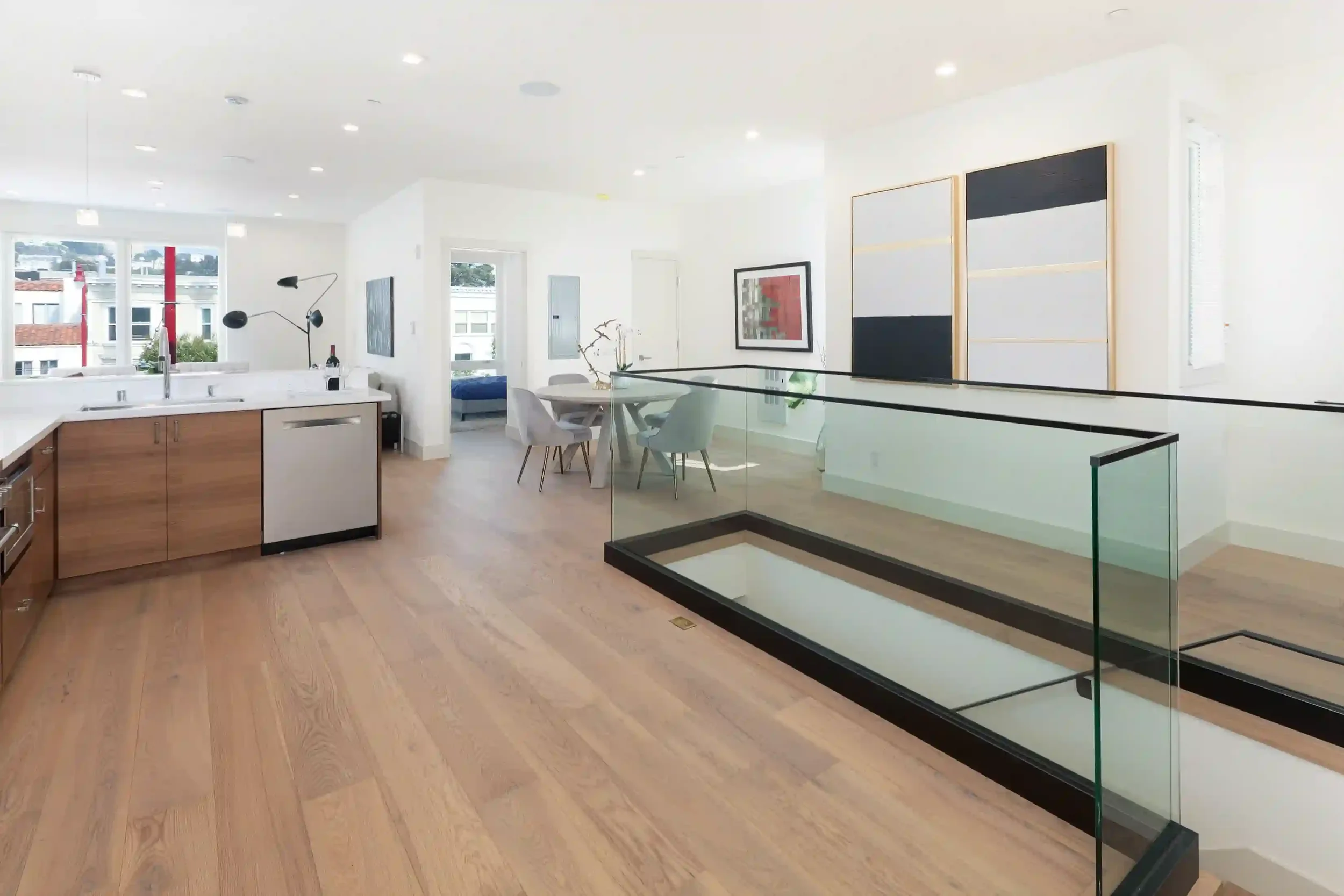 Multi-unit condo living area supported by structural retrofit and open-plan configuration