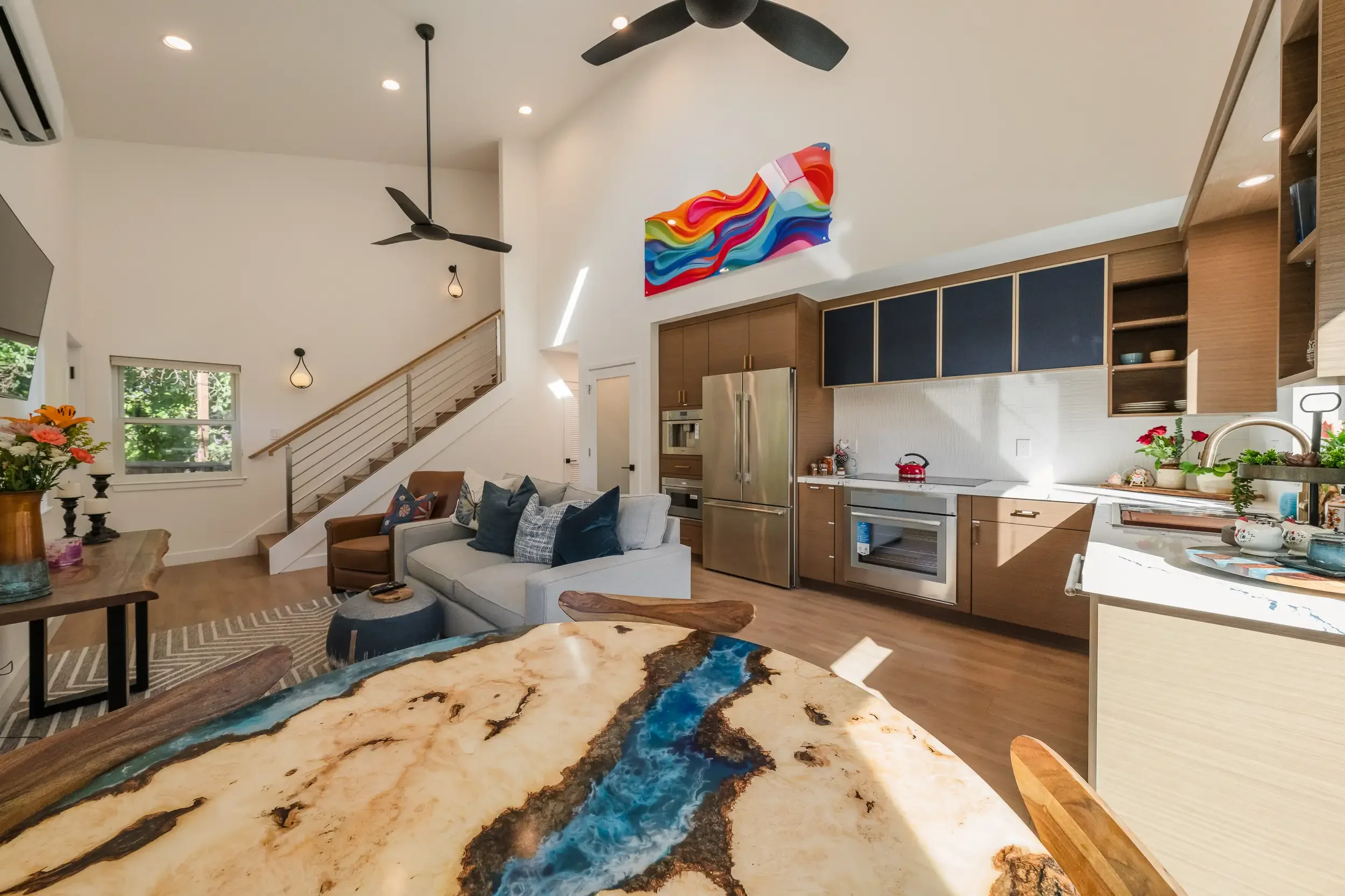 This detached ADU in San Jose features an open-concept living room and kitchen with high vaulted ceiling, ceiling fans, structural engineering and architectural design by Massoudi Consulting Engineers.