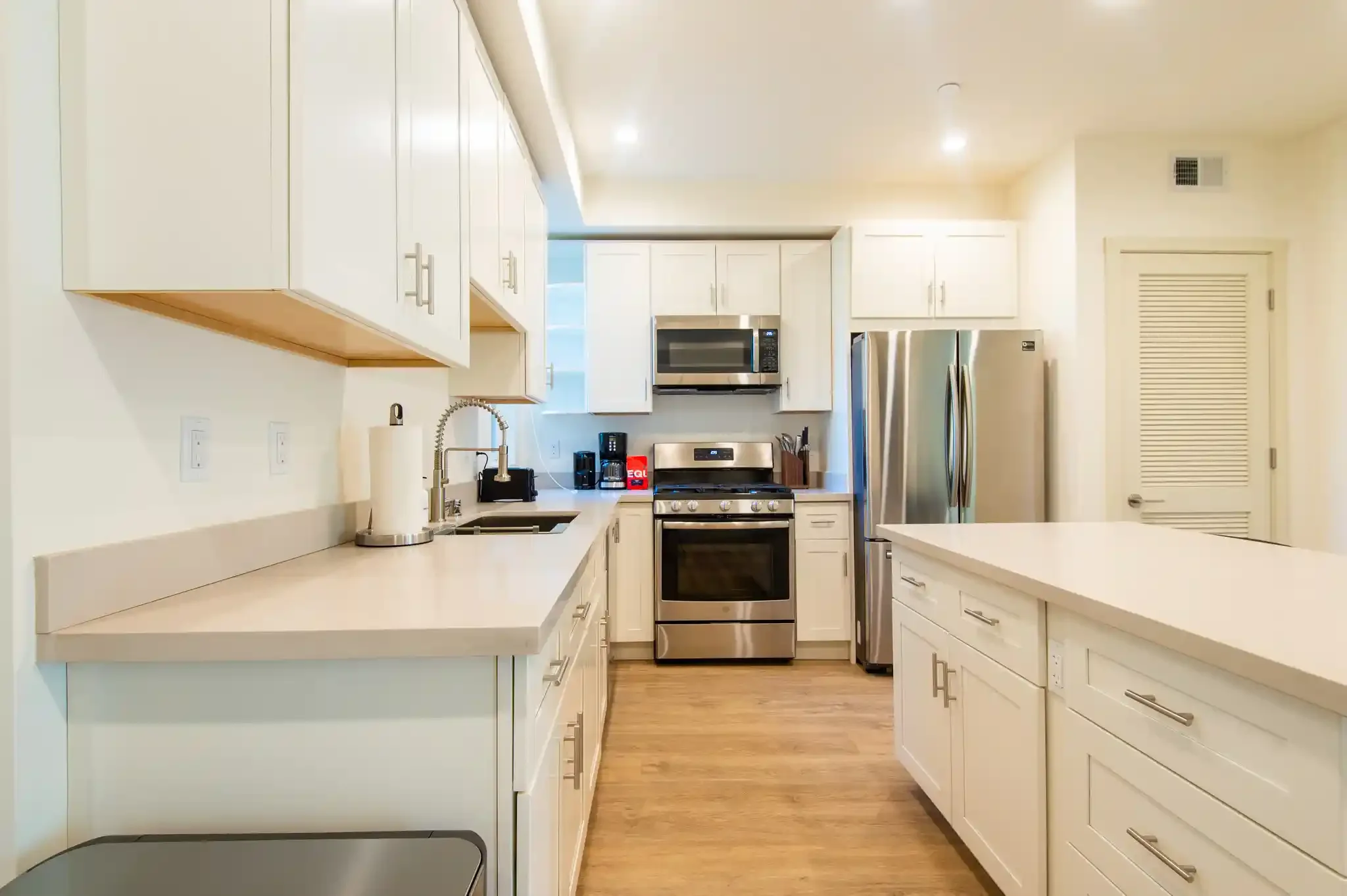 Close-up of kitchen cabinetry and countertops, part of new structural framing