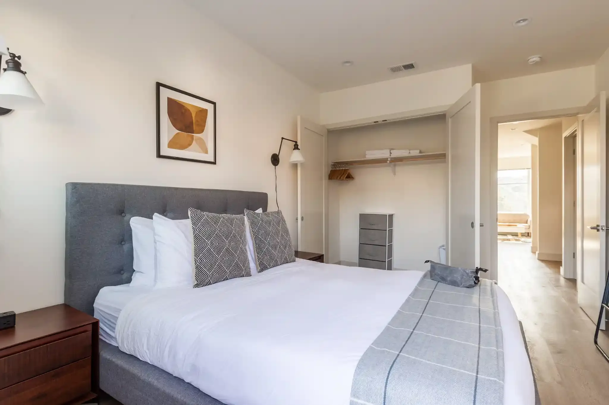 Bright bedroom with large bed and corner windows in San Francisco duplex
