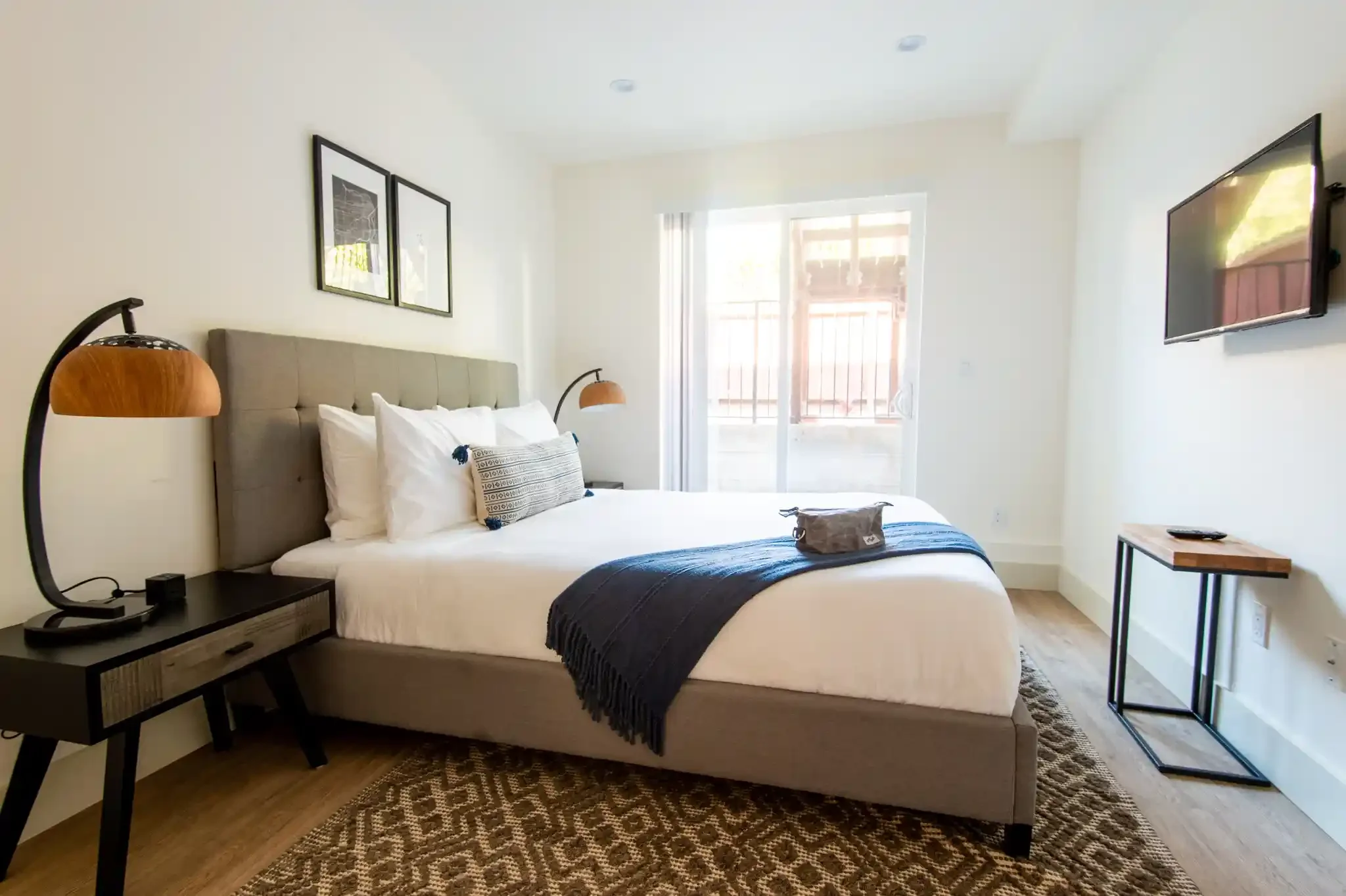 Guest bedroom with custom lighting and art, part of duplex reconfiguration