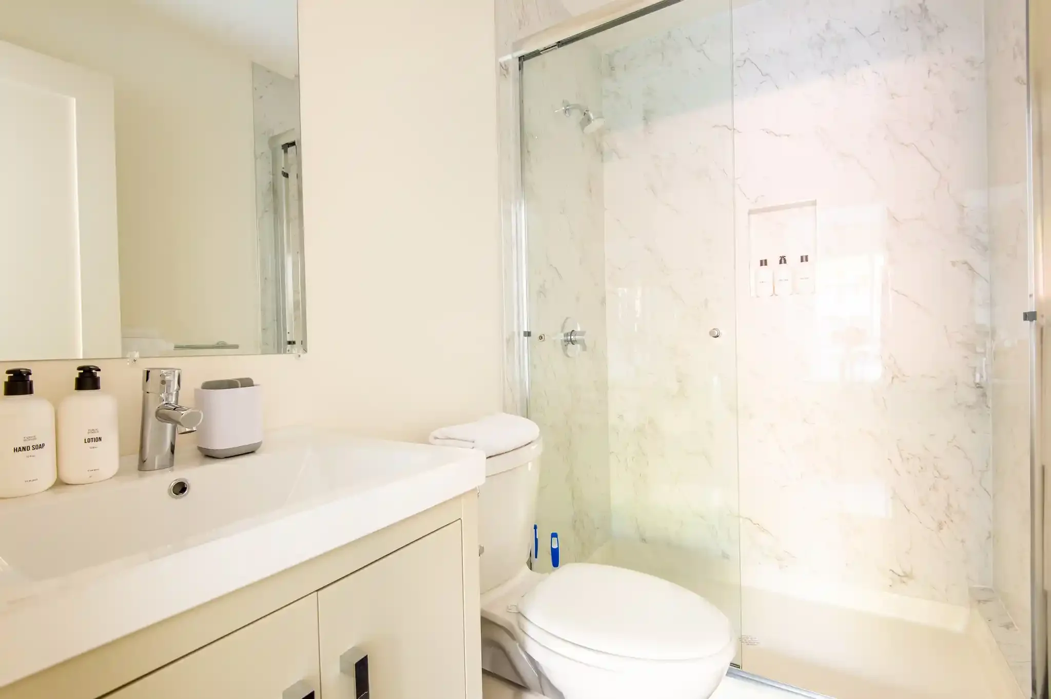 Vanity and mirror in ADU bathroom showing compact architectural detailing