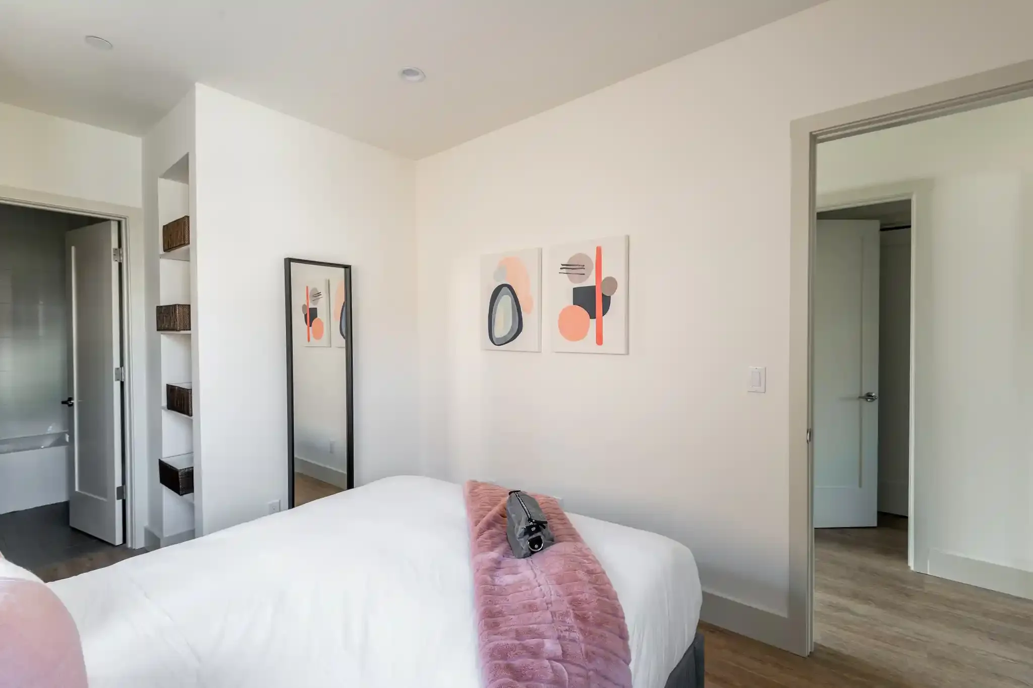 Bedroom with large window and wall art, designed for efficient layout in duplex