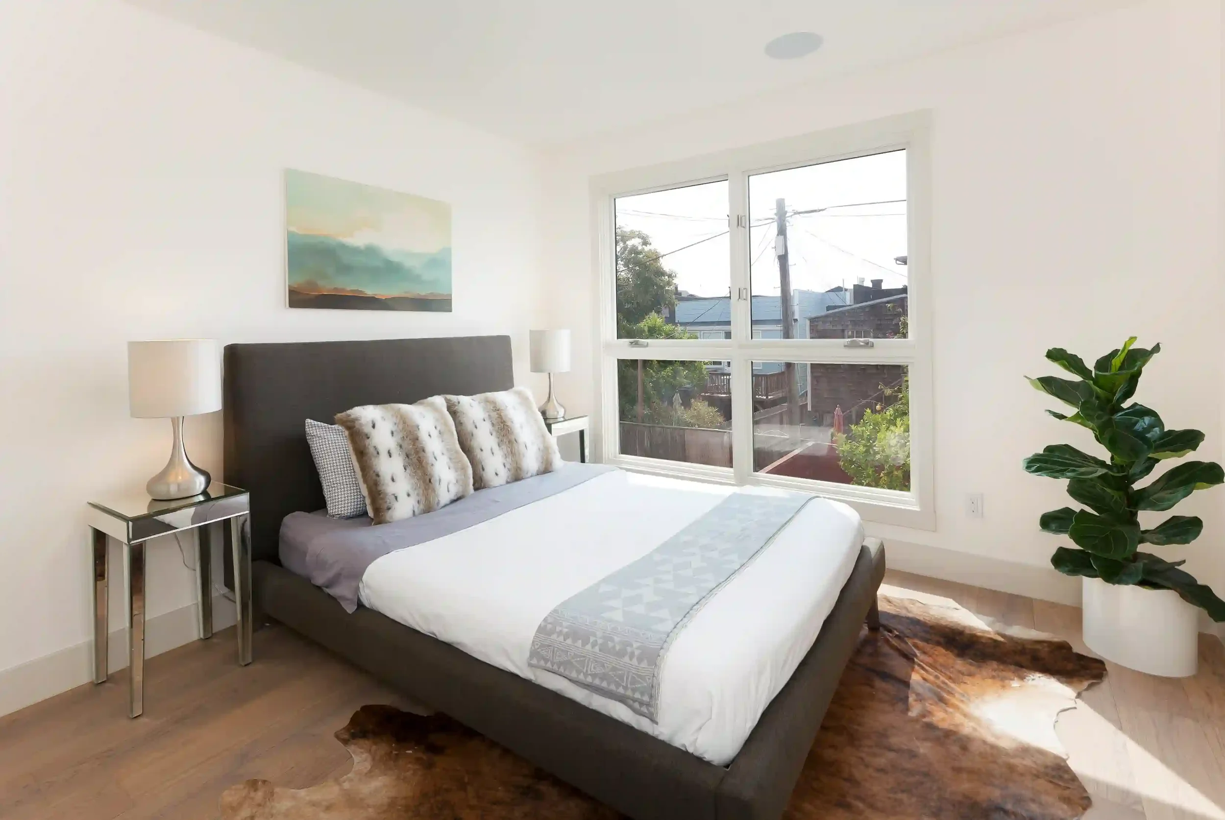 Modern bedroom in San Francisco condo showing beam support for vaulted ceilings