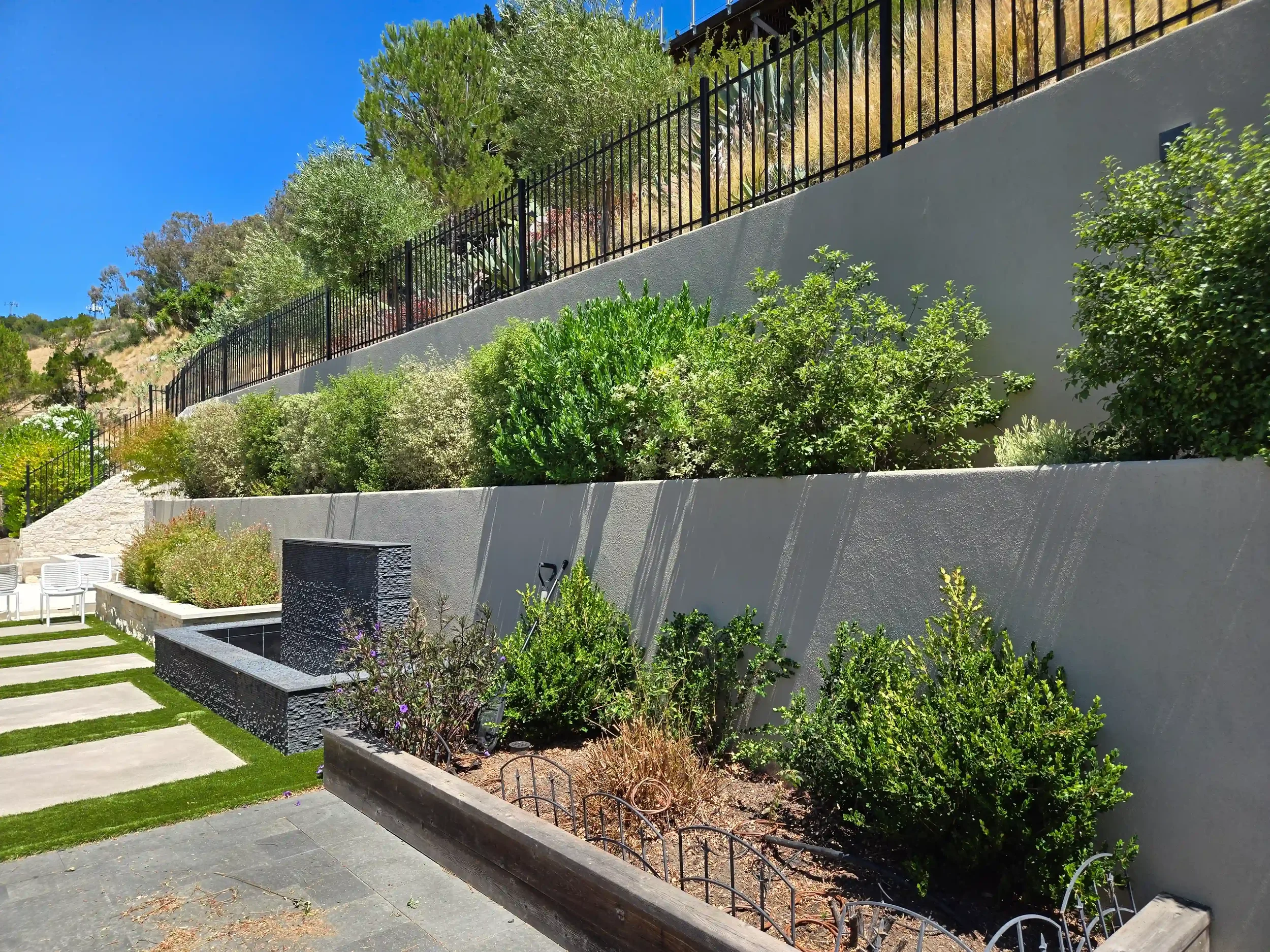 Detailed view of retaining wall engineered by Massoudi Consulting Engineers, ensuring long-term structural integrity and efficient water management for residential construction.