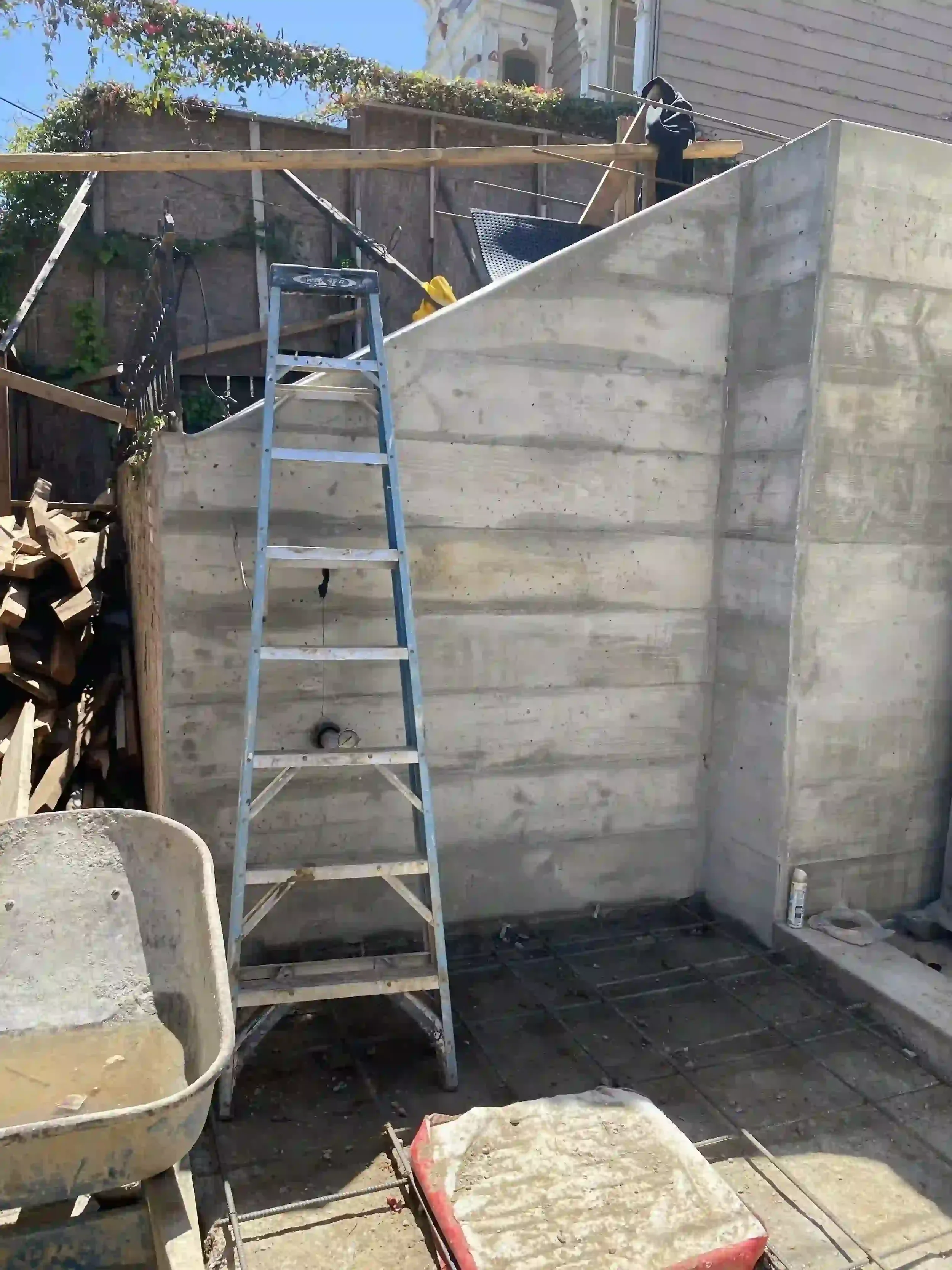 In-progress retaining wall pour with waterproofing and structural civil detailing by Massoudi Consulting Engineers