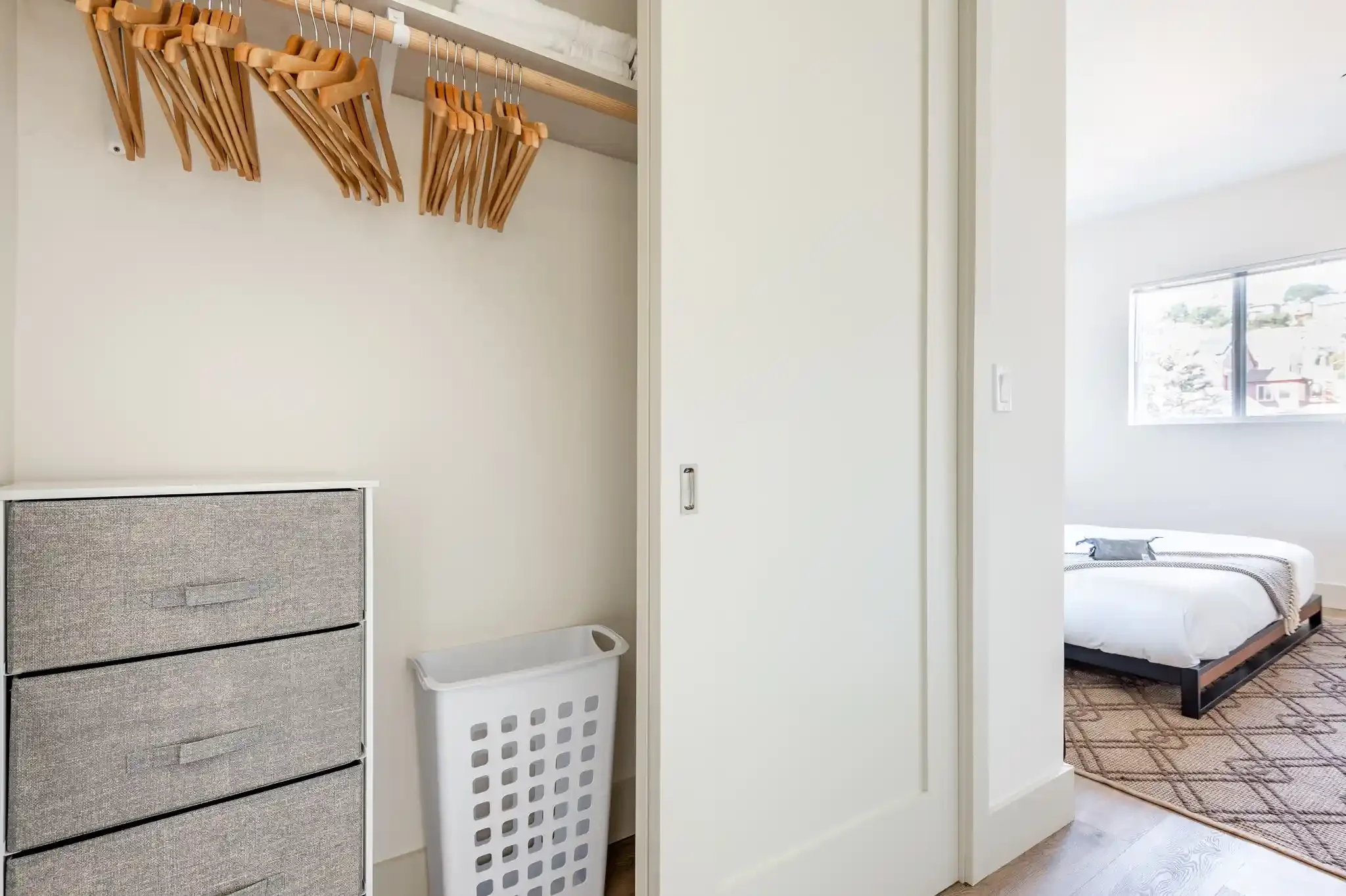Bedroom with built-in closet and dresser, part of new duplex design in San Francisco