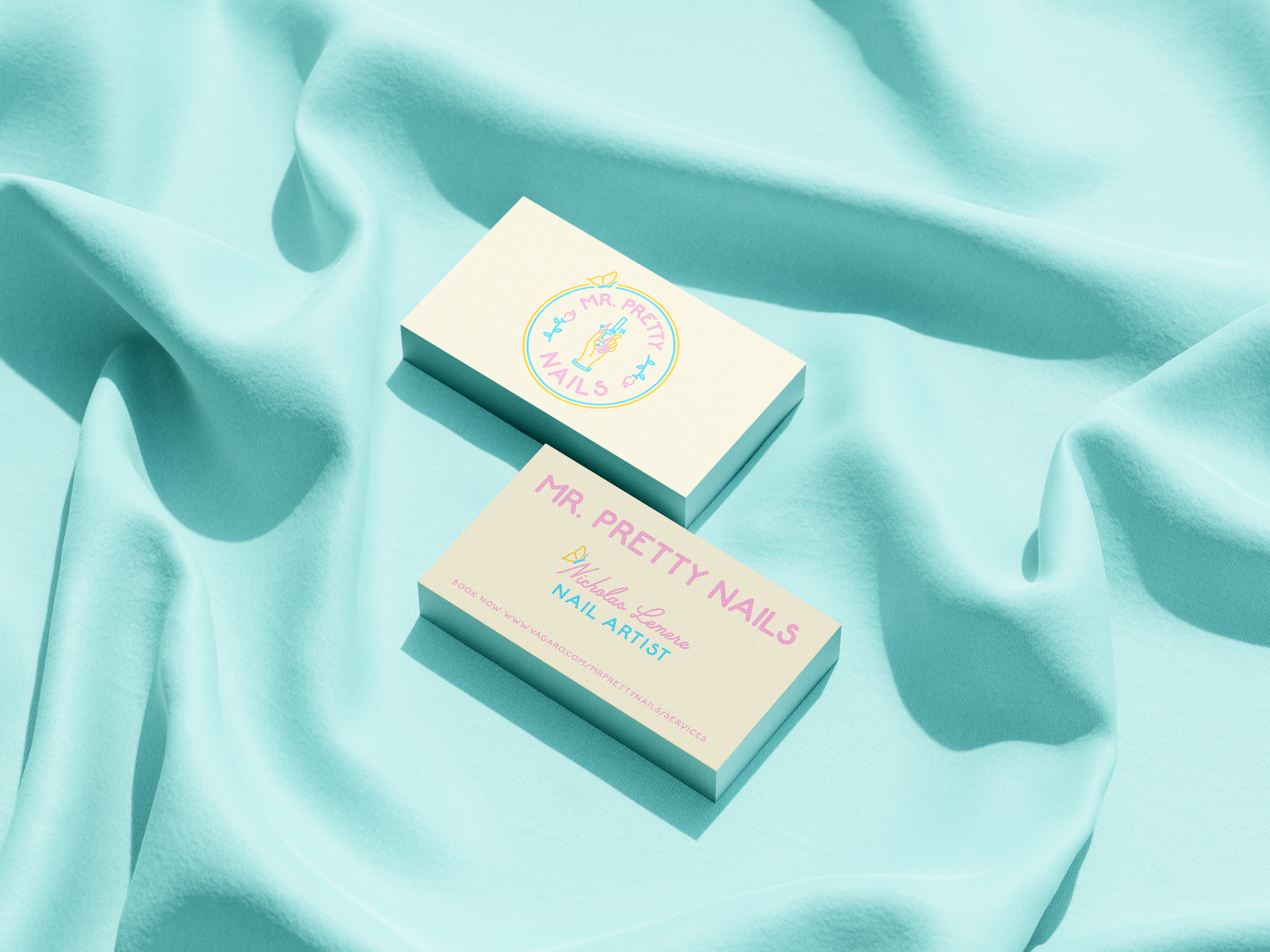 Pack of nails with a colorful label reading "Mr. Pretty Nails," surrounded by soft, light blue fabric.
