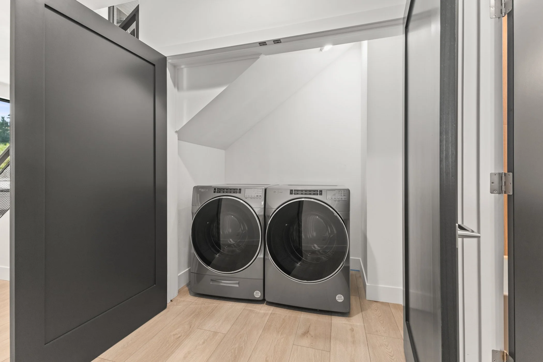 Modern laundry room with washer and dryer in a closet.
