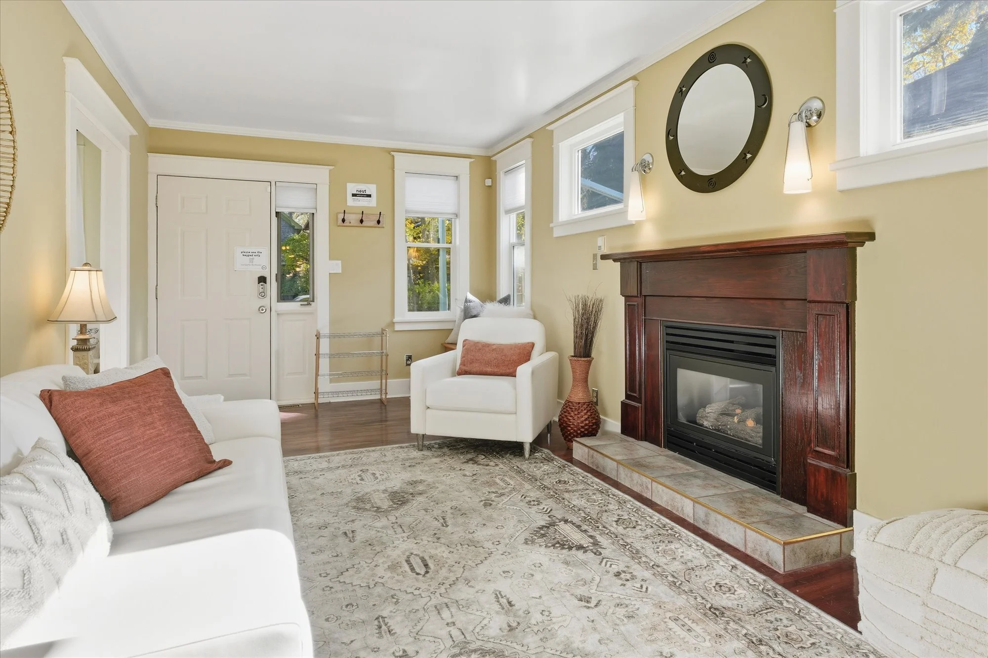 offering a warm and inviting living room complete with relaxing boho vibes, a gorgeous gas fire place for those chillier days.