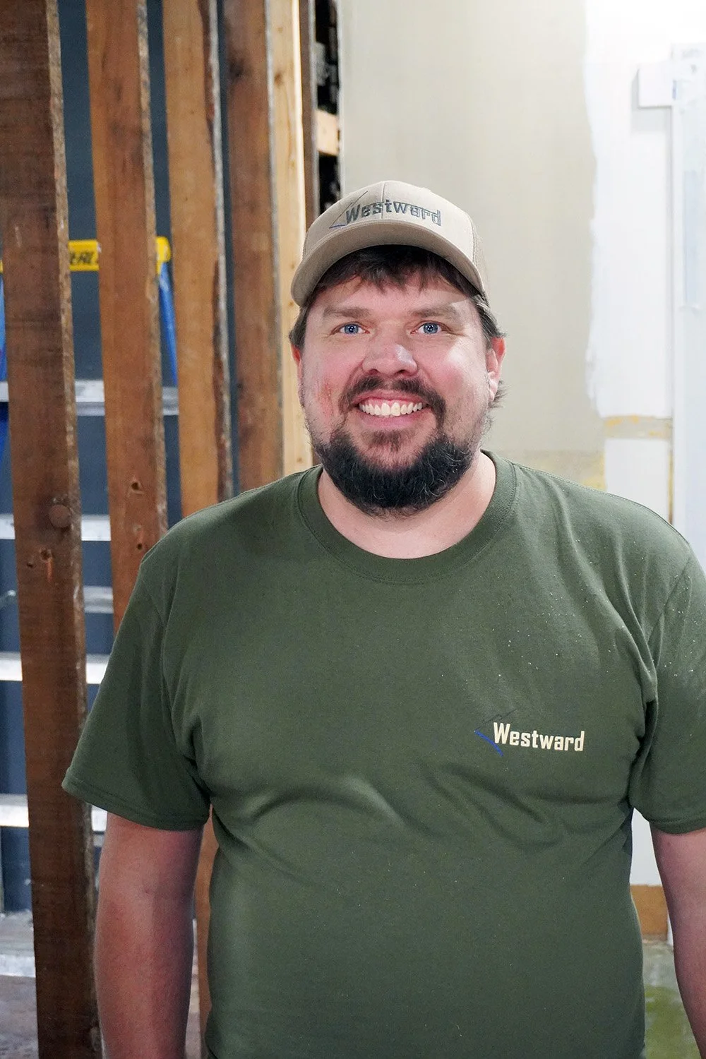 A photo of a carpenter smiling