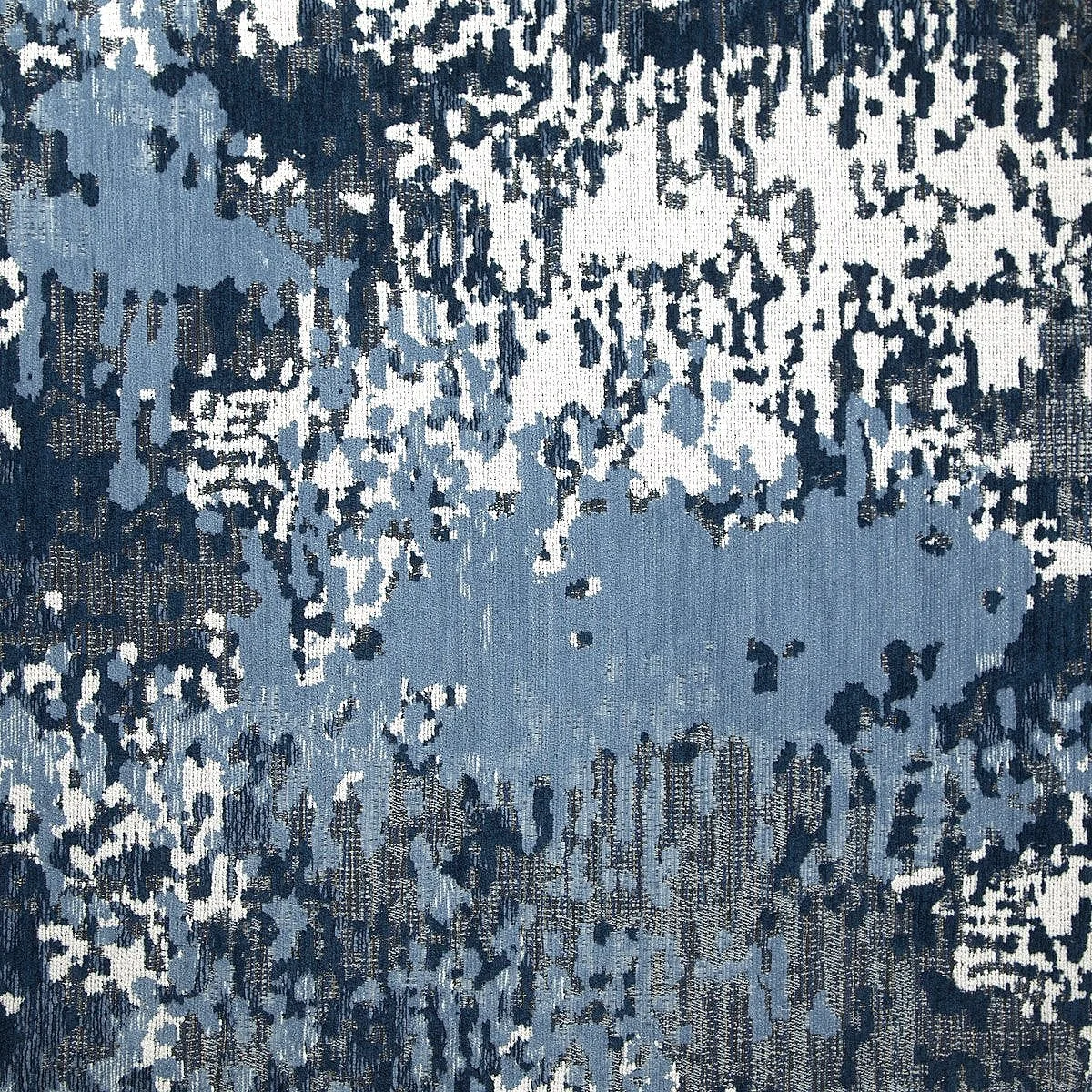 Abstract blue and white textured pattern resembling a camouflage or artistic paint splatter on fabric.