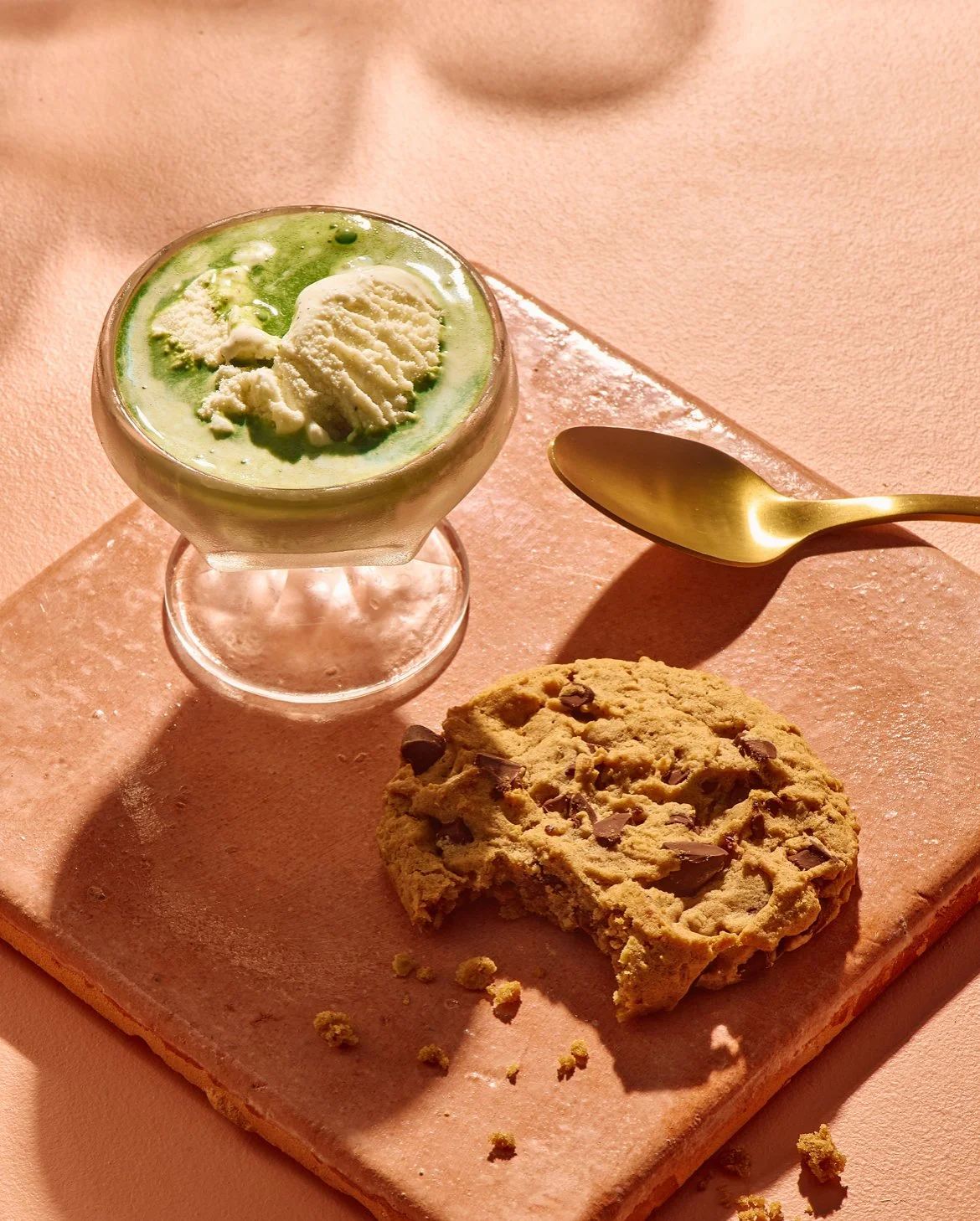 Matcha-gato - Vanilla ice cream topped with matcha tea, beside a L'SETTE chocolate chunk oatmeal cookie