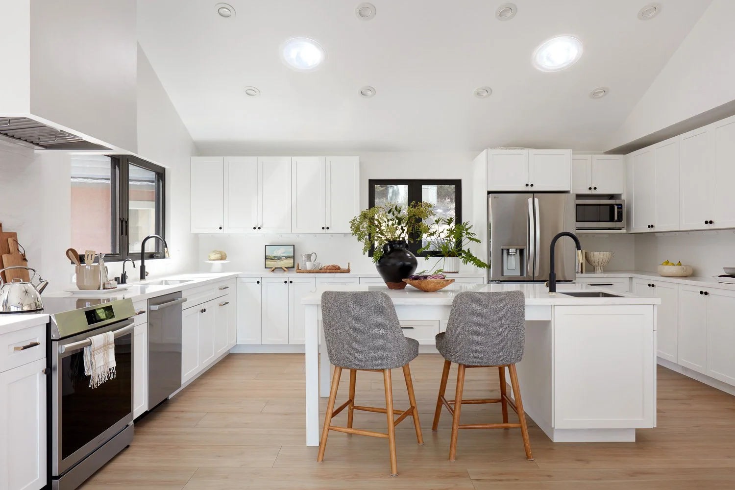 A bright, open kitchen designed to maximize natural light, clean lines, and seamless connection to the surrounding views.
