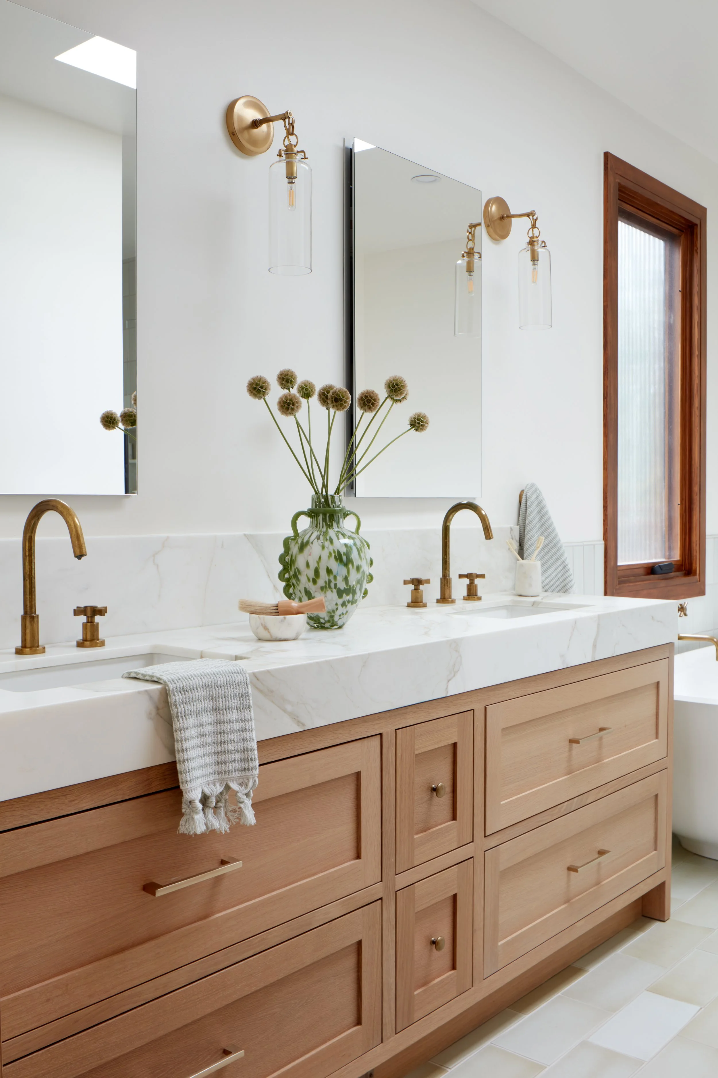Spa-inspired bathroom design with custom cabinetry and stone countertops in this San Mateo luxury home renovation.