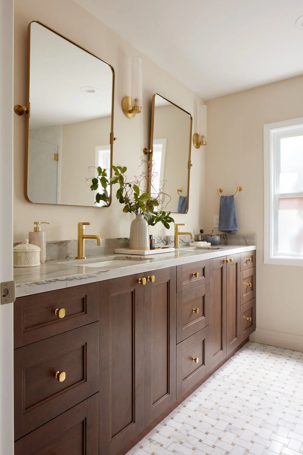 Spa-like shower with slab walls and brass fixtures – custom home remodel