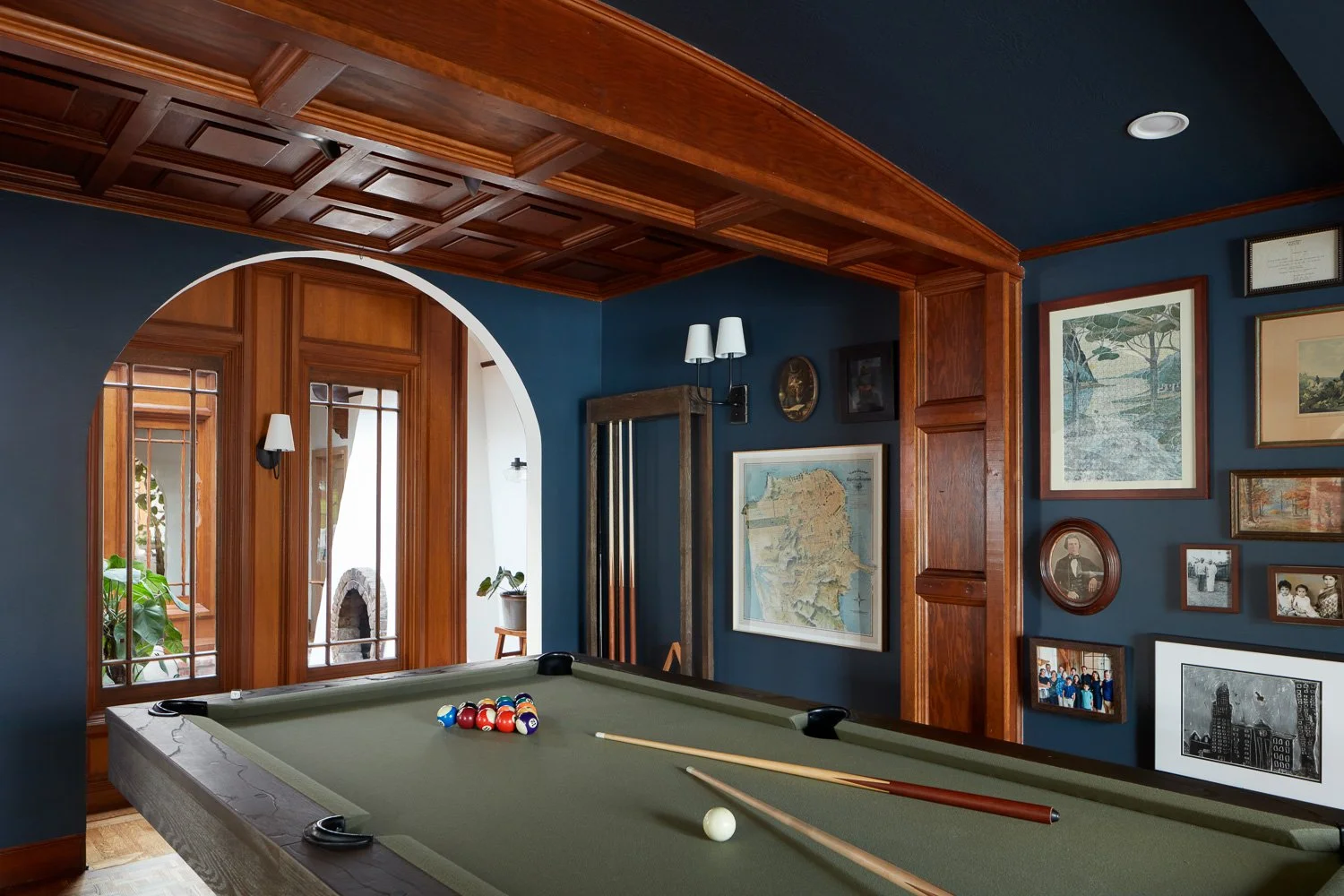 A refined game room featuring custom millwork, deep tones, and a classic pool table for elevated entertaining.