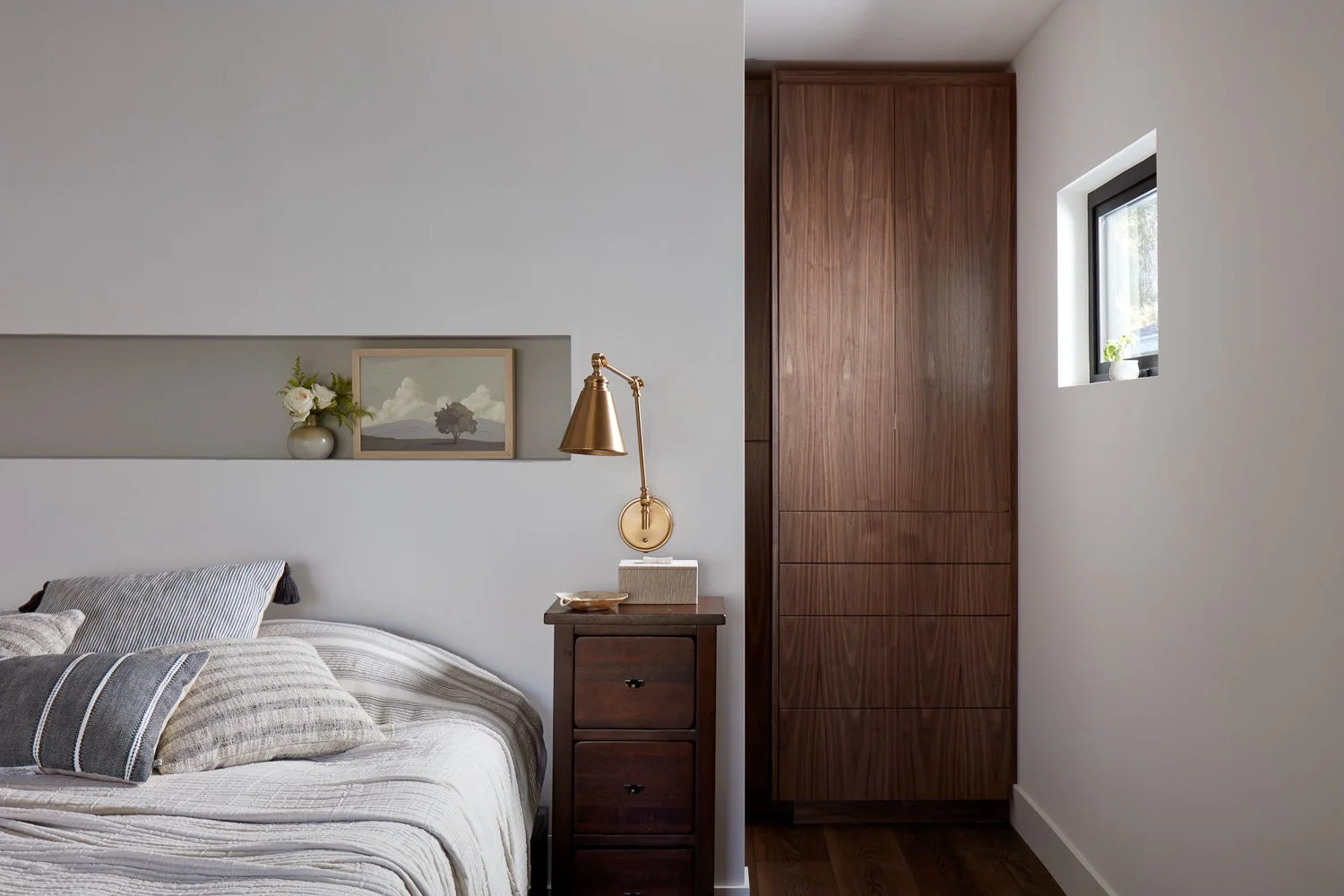 A calm, modern bedroom featuring custom storage and clean lines, designed for comfort in this new construction home.