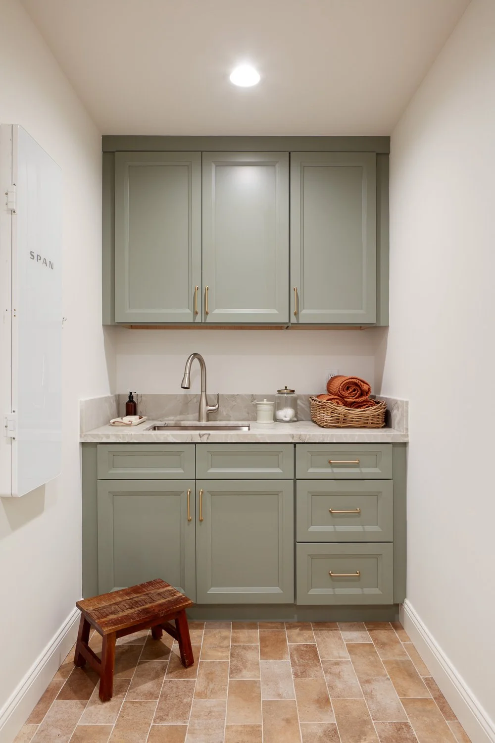 Custom laundry room with built-in cabinetry and stone counters – custom home remodel.