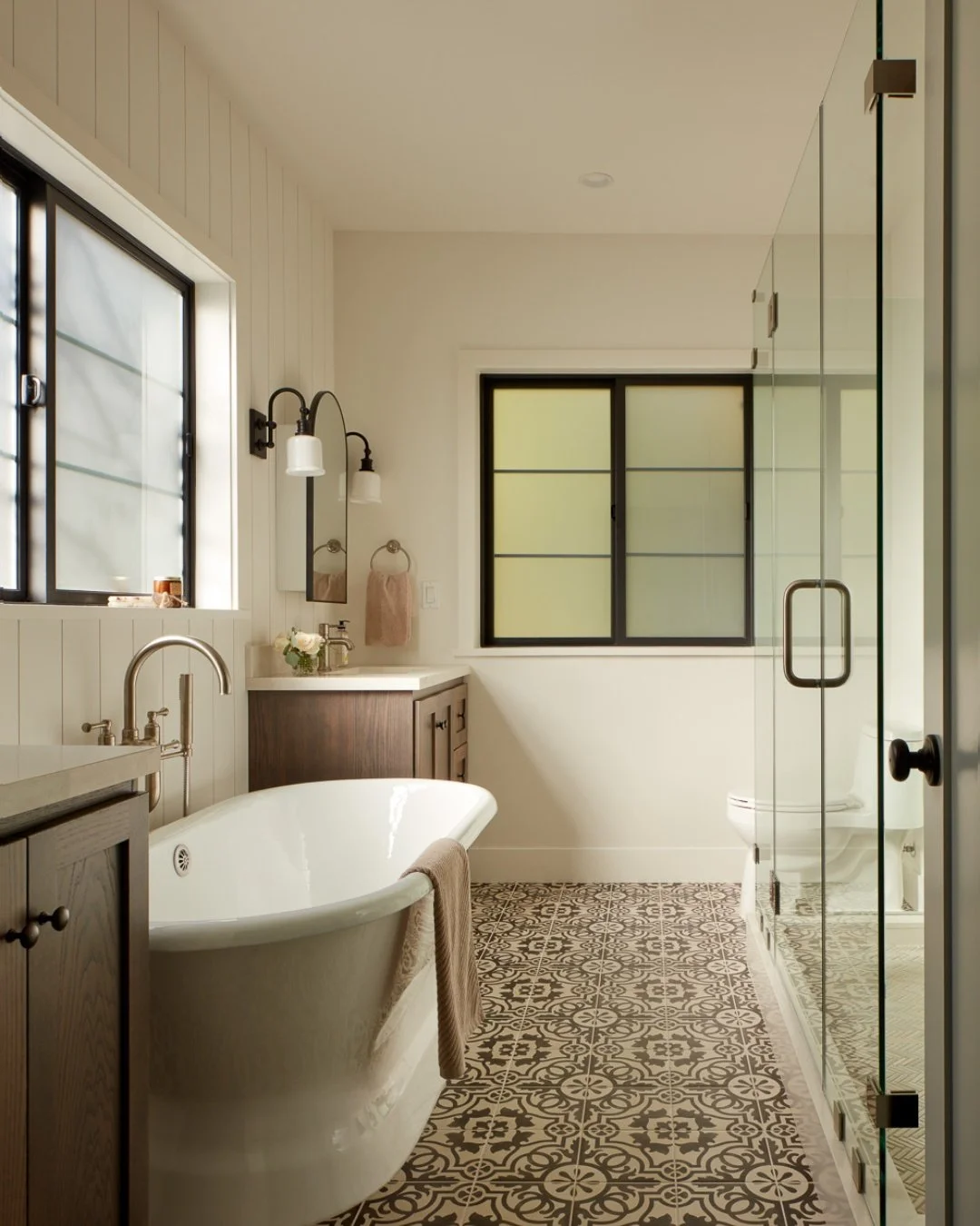 Coastal Warmth &amp; Timeless Texture 🌊
Every detail of this Pacifica primary bathroom remodel was designed to create a grounded, spa-like sanctuary. By pairing crisp, vertical shiplap walls with rich, dark wood vanities and patterned floor tiles, w