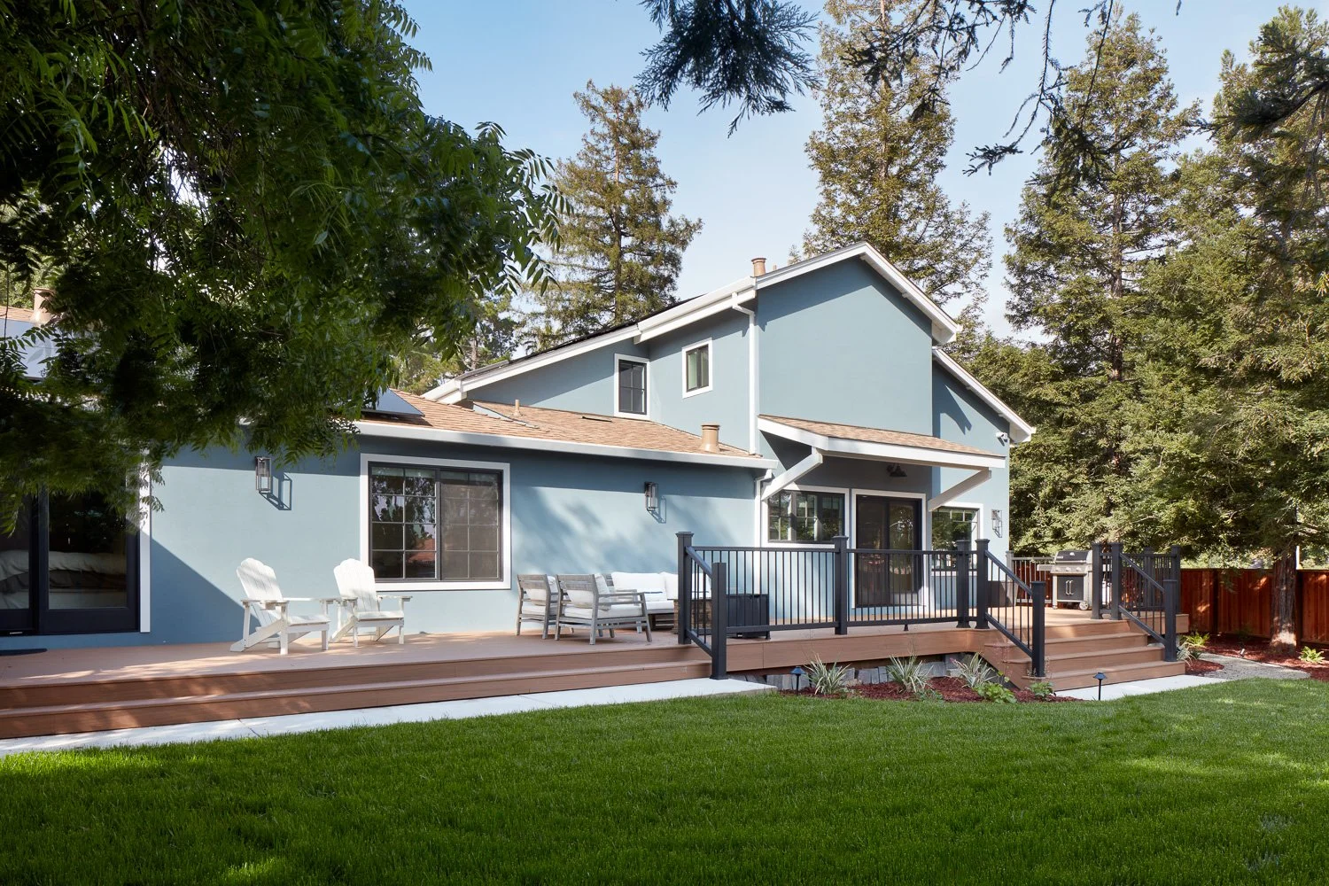 Modern rear elevation with addition and expansive deck – custom home remodel.