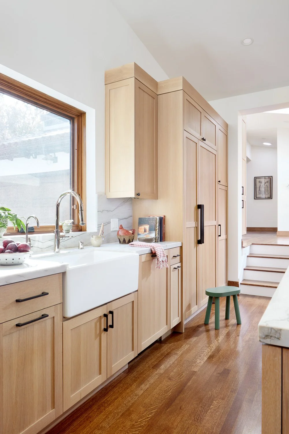 Farmhouse sink and custom pantry cabinetry add warmth and function to this high-end San Mateo kitchen remodel.