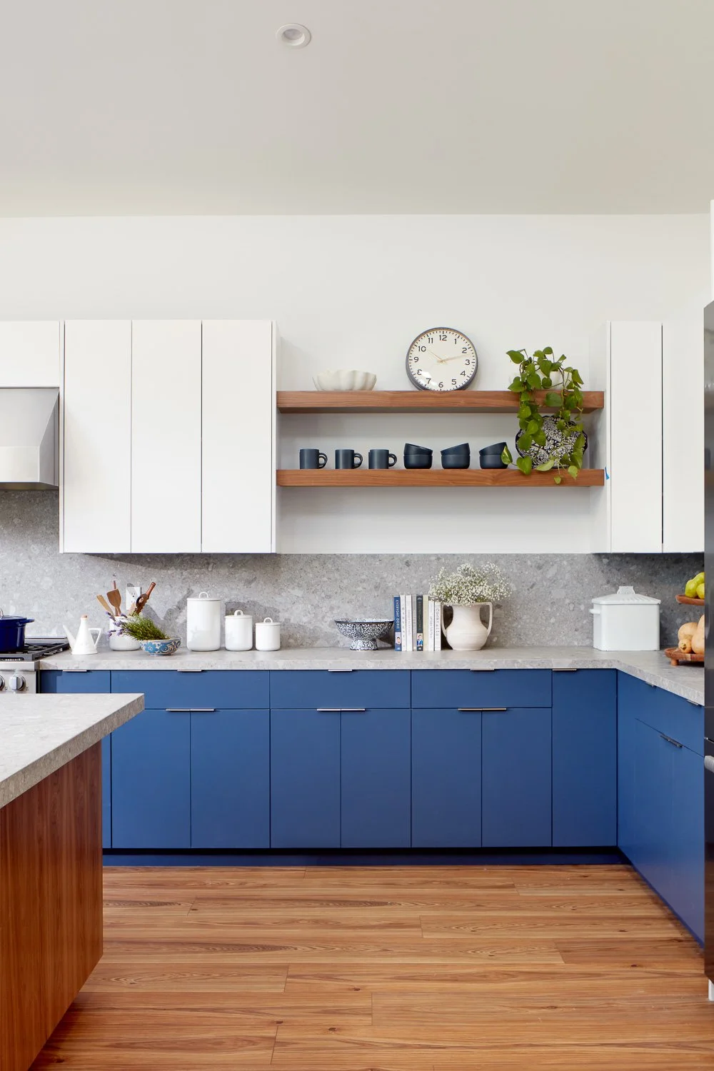 Thoughtful kitchen details and open shelving add warmth and function to this custom new construction home.