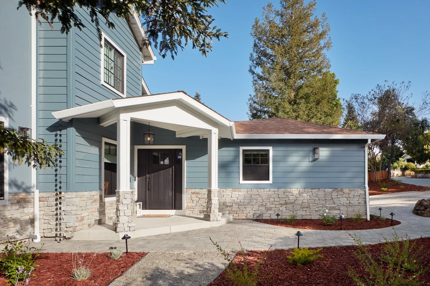 Inviting entry with covered porch and clean architectural lines – custom home remodel.
