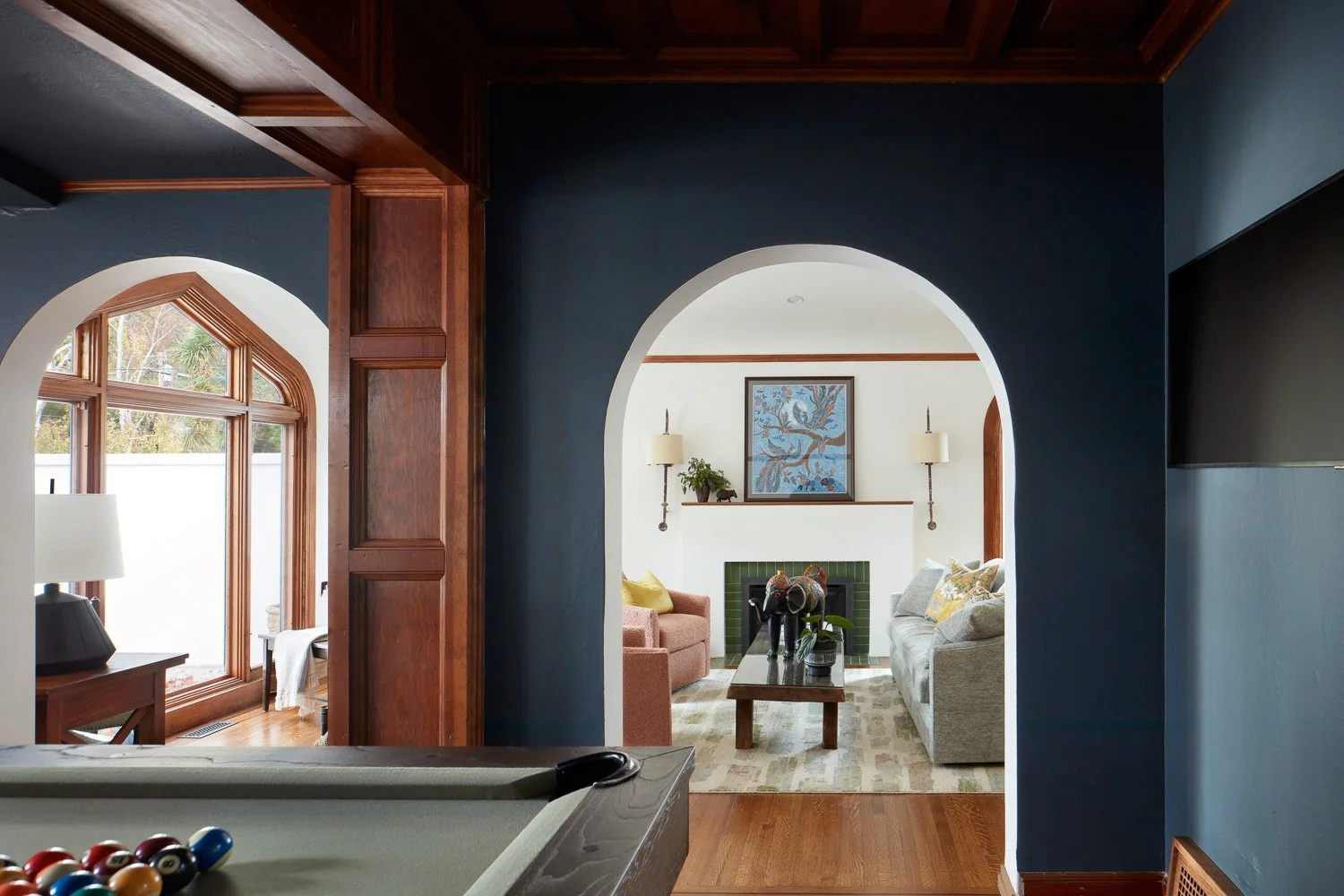 A refined game room featuring custom millwork, deep tones, and a classic pool table for elevated entertaining.