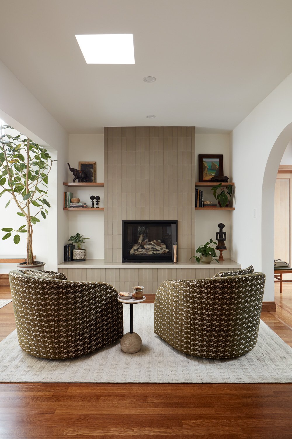 A refined sitting area anchored by a tiled fireplace and soft textures, perfect for quiet moments at home.