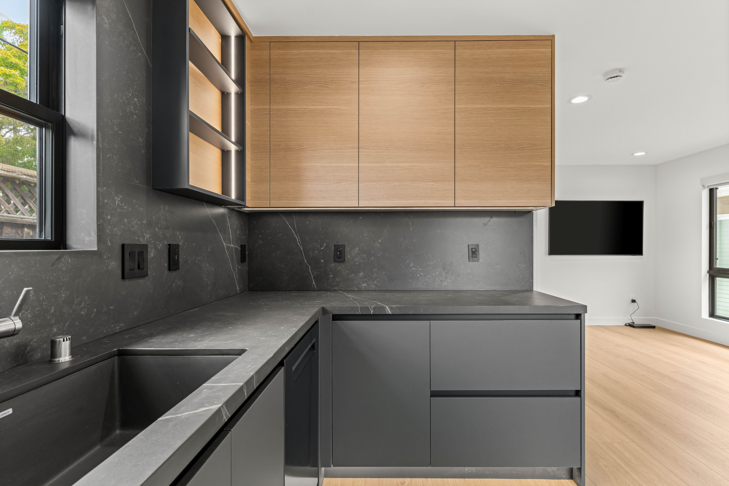 Accessory Dwelling Unit kitchen in San Jose with custom cabinetry, quartz surfaces, and modern black finishes.