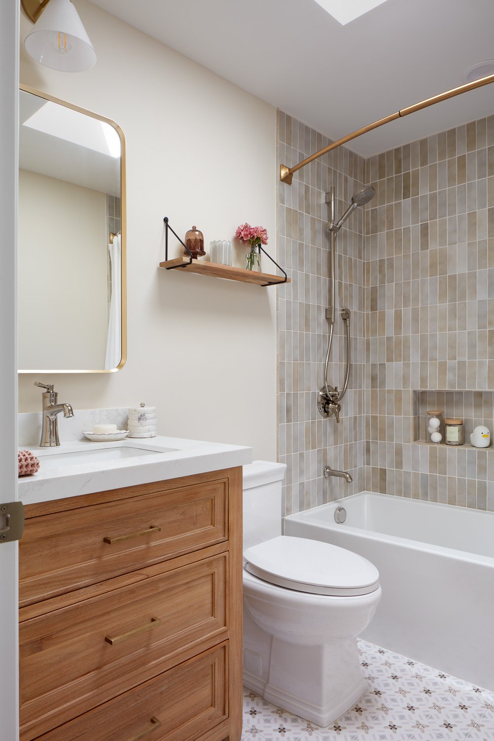 Modern guest bath with clean tile and brass accents – custom home remodel.