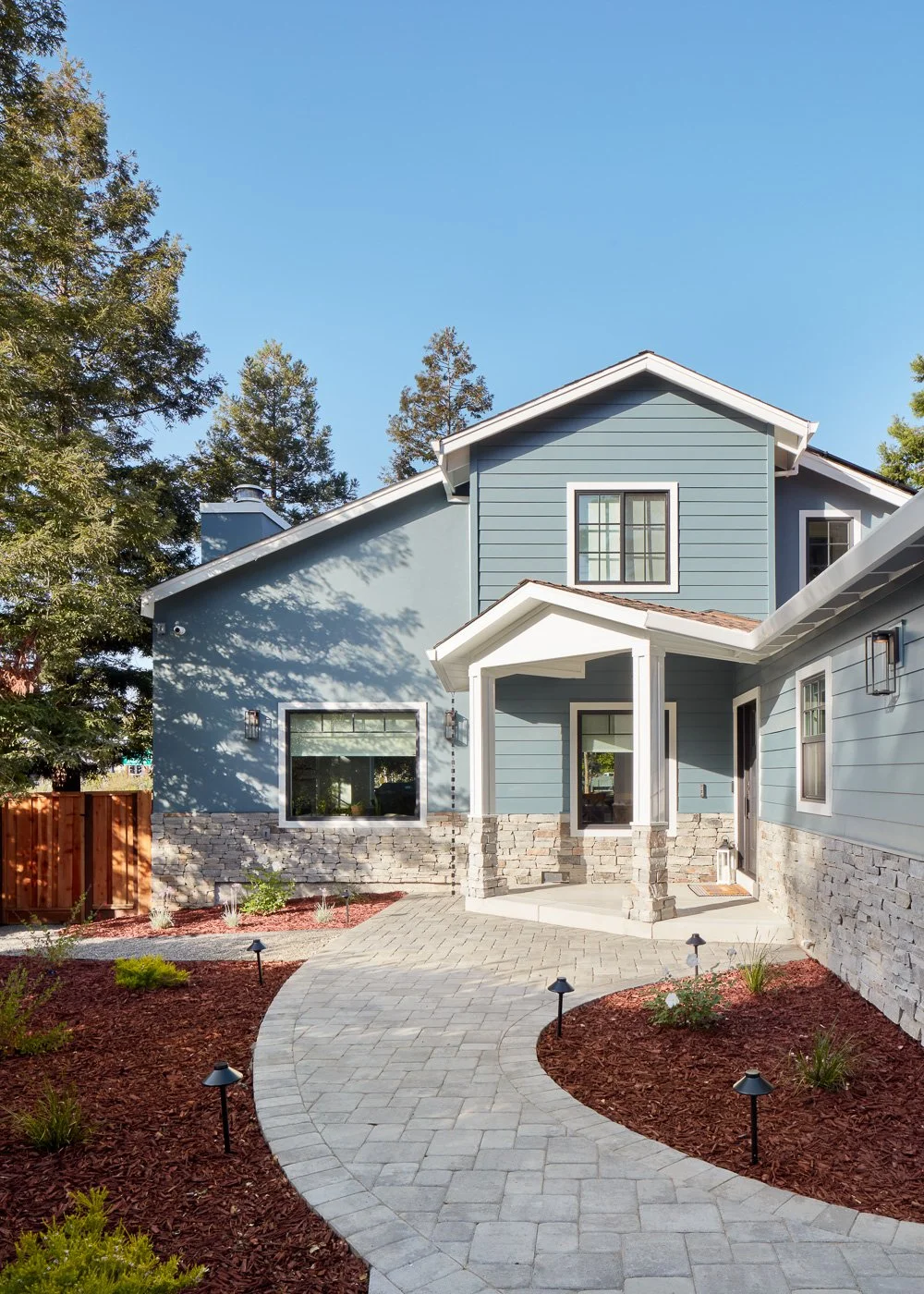 Refined exterior with modern colors and upgraded hardscape – custom home remodel.