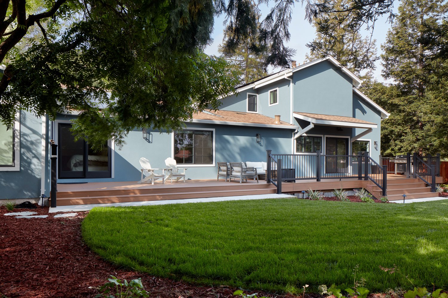 Full exterior upgrade with extended deck and open layout – custom home remodel.