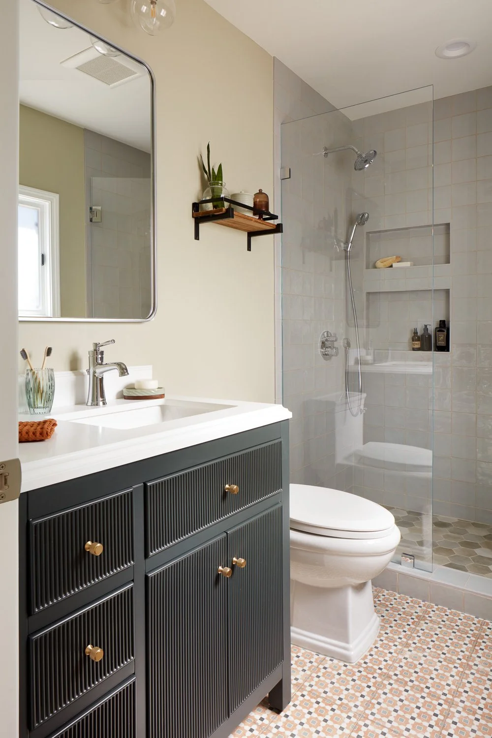 Modern bathroom with custom vanity and frameless glass shower – custom home remodel.