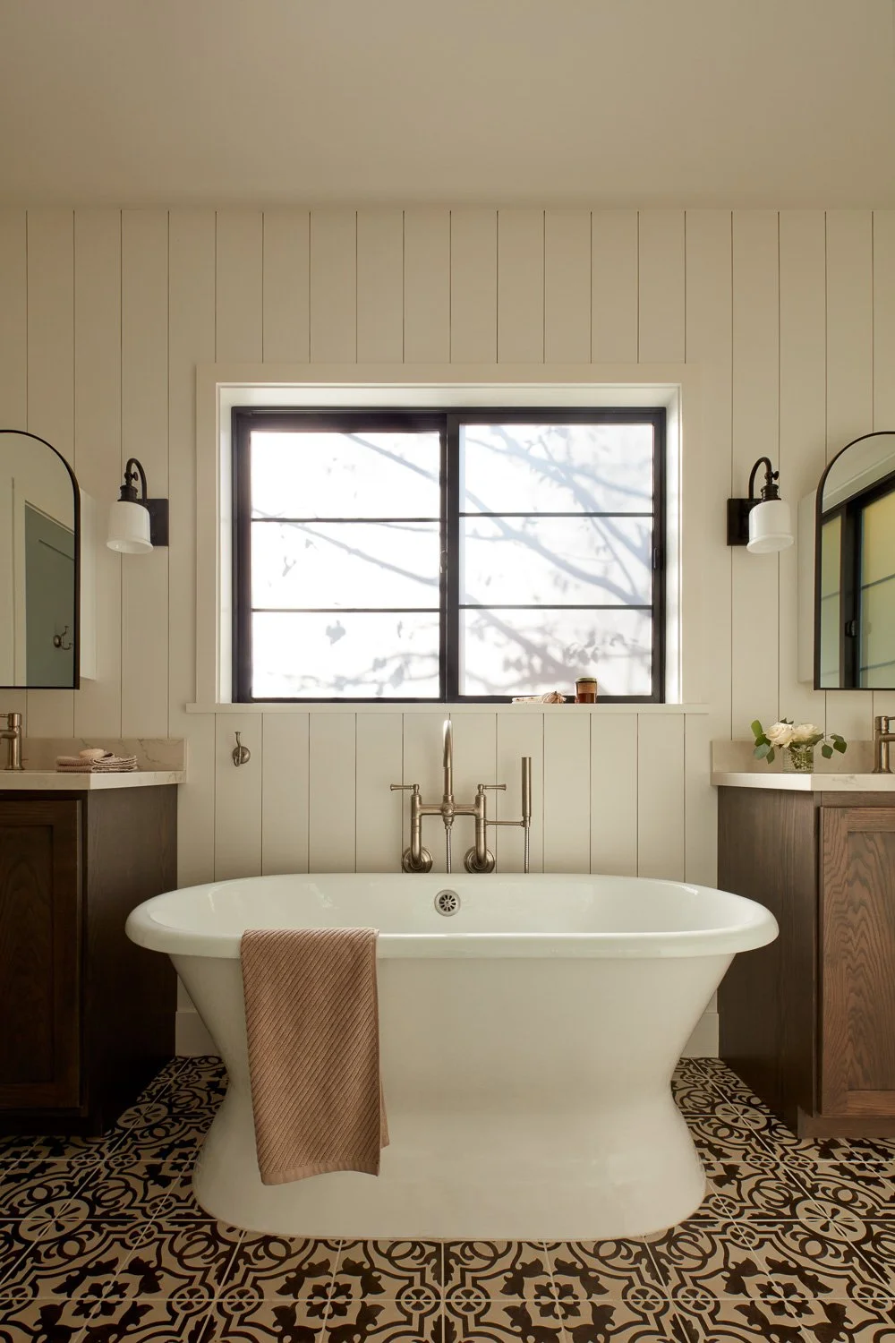 Symmetrical master bathroom with freestanding tub, shiplap walls, black-framed window, and custom vanities in Pacifica home remodel