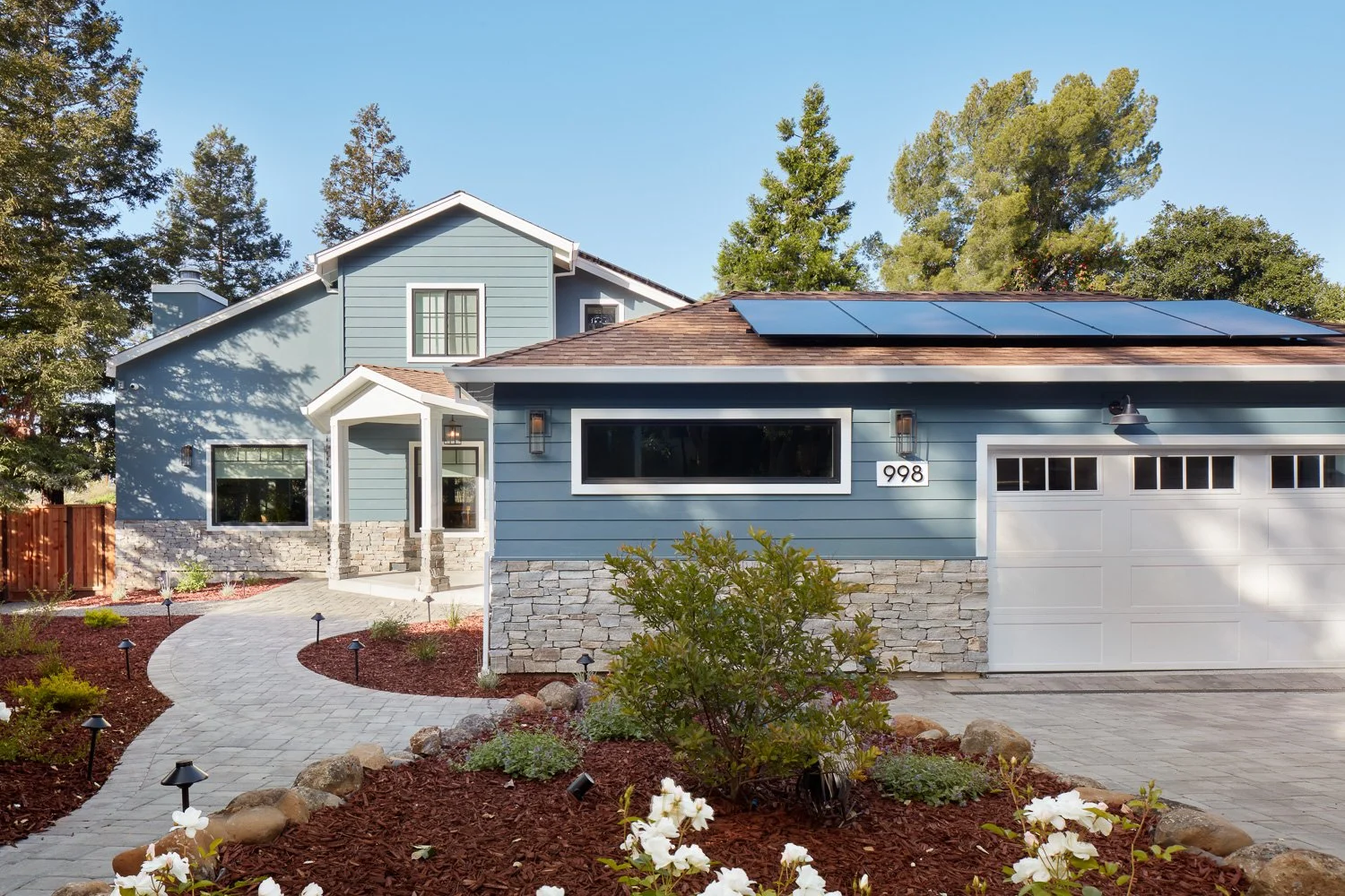 Full exterior transformation with landscaping and solar integration – custom home remodel.