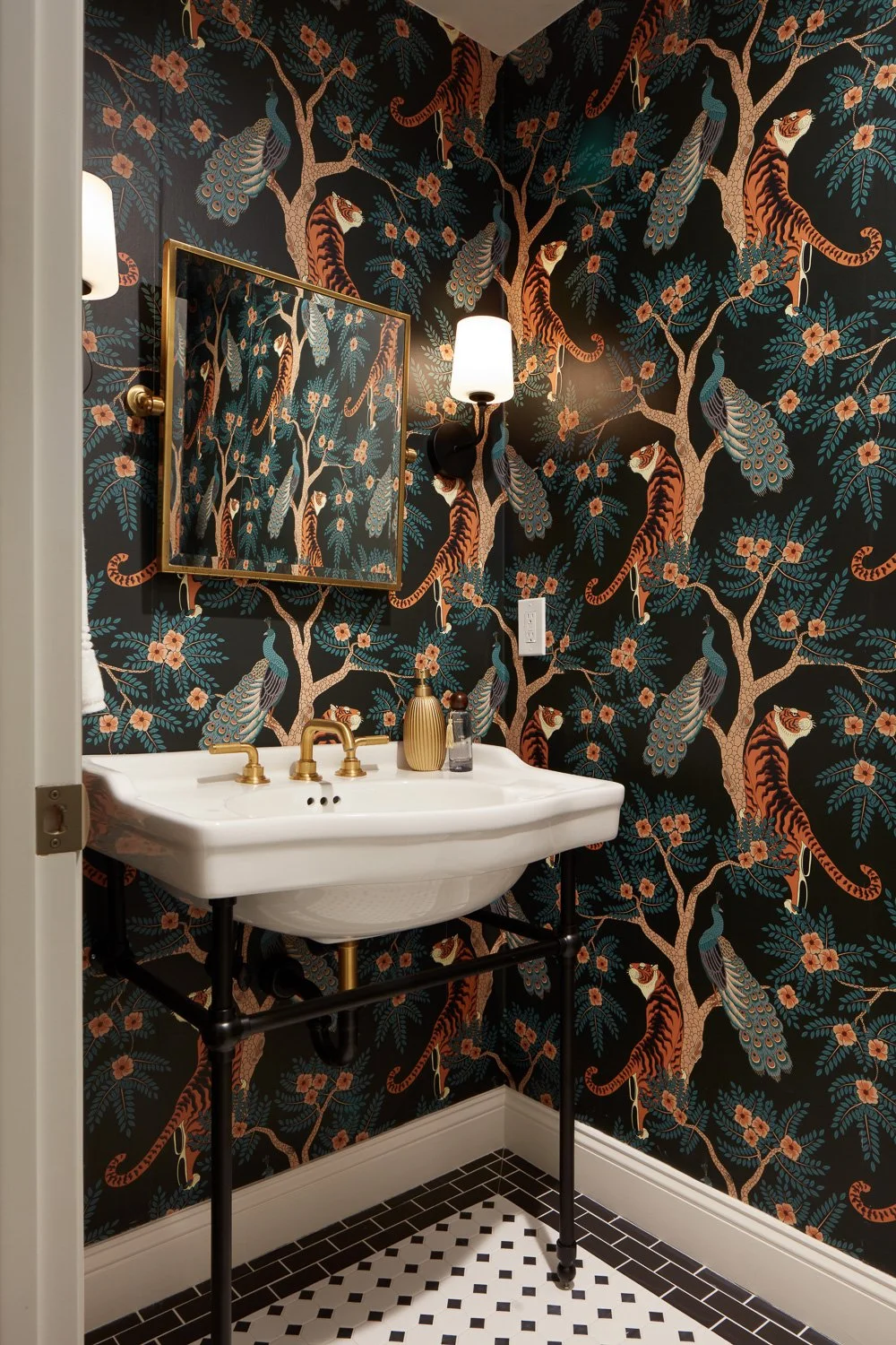 Bold powder room with designer wallpaper and brass fixtures – custom home remodel.