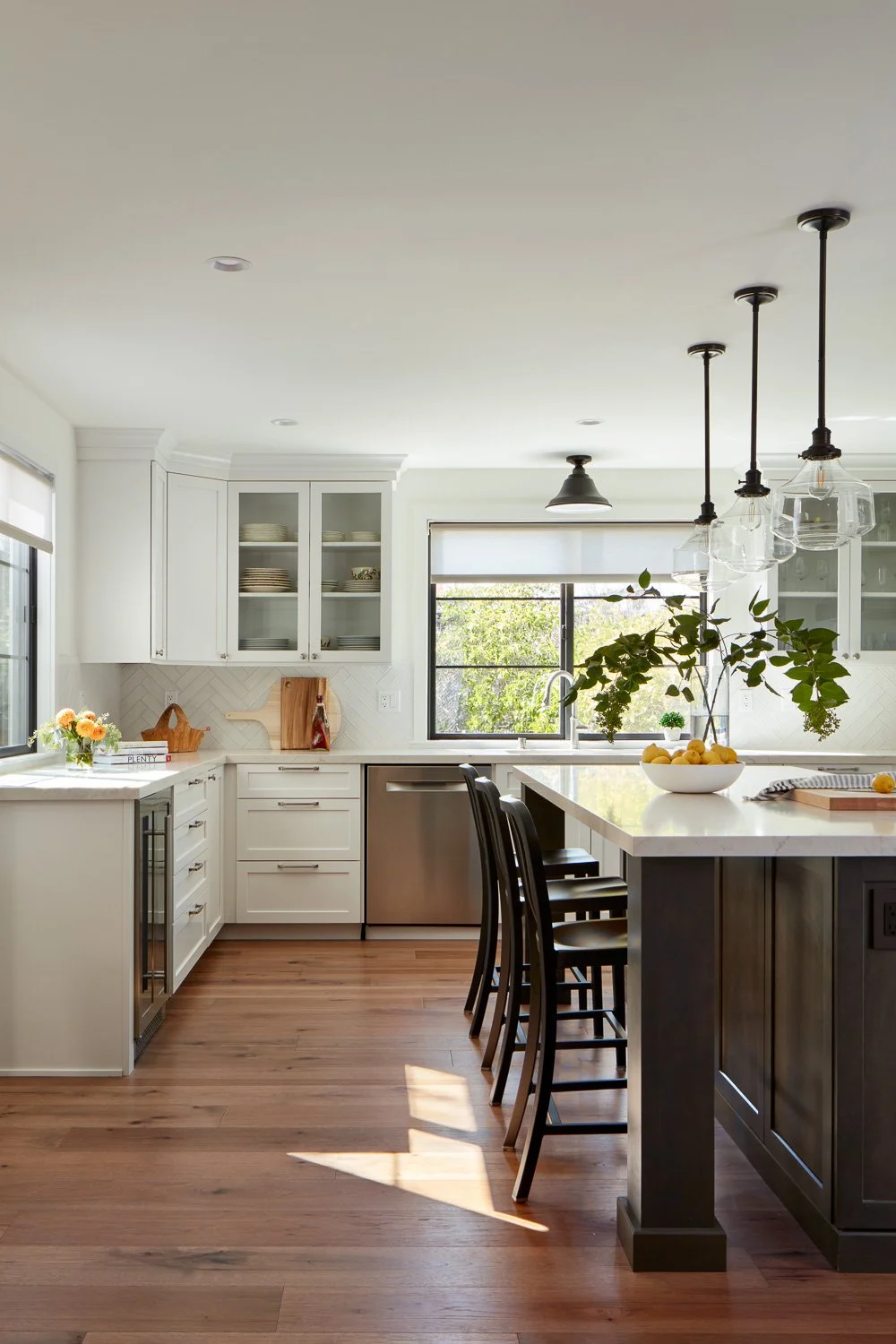 Bright Pacifica kitchen renovation with custom cabinets, quartz countertops, island seating, and natural light.