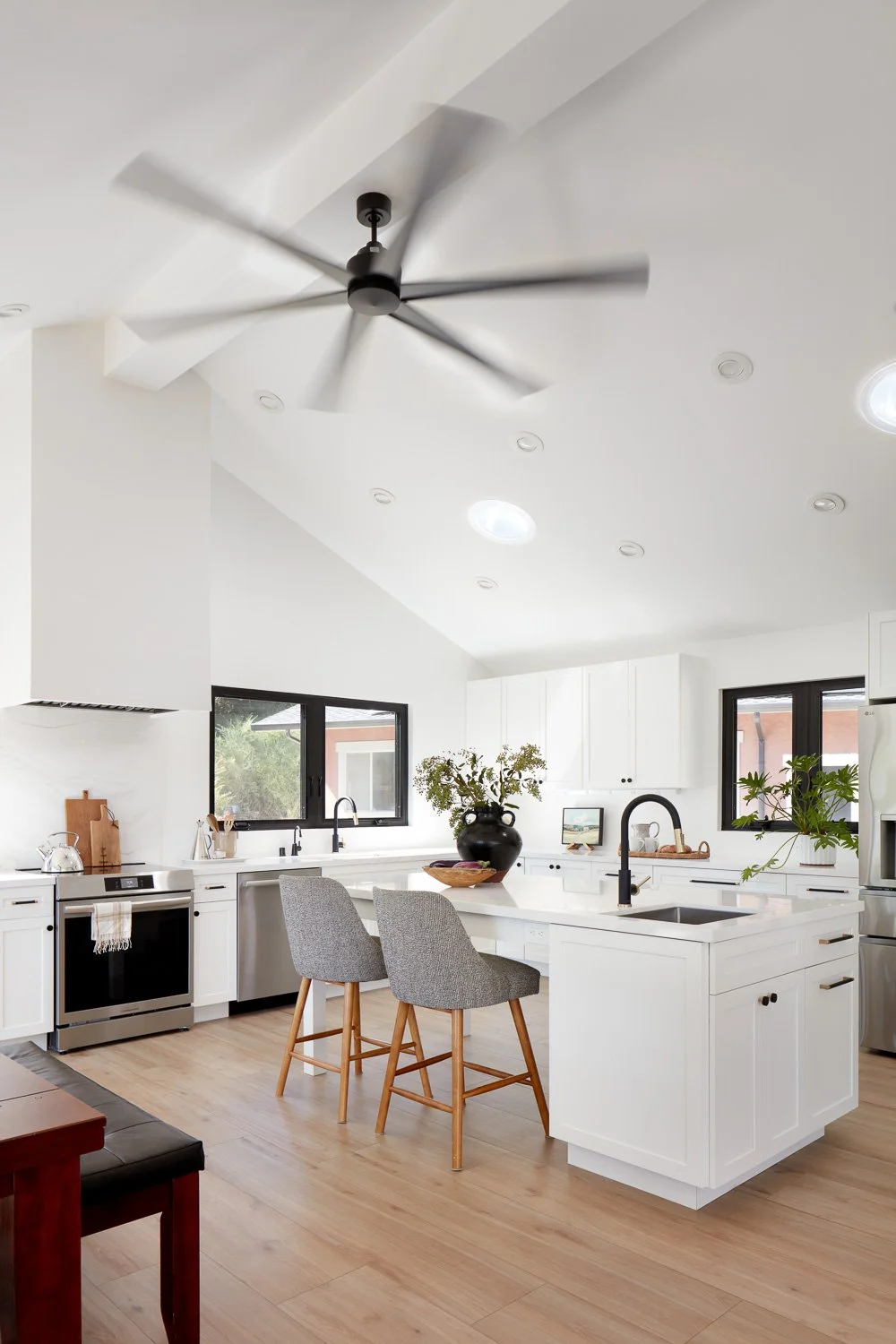 A bright, modern kitchen with clean lines, oversized island seating, and mountain views that anchor the heart of the home.