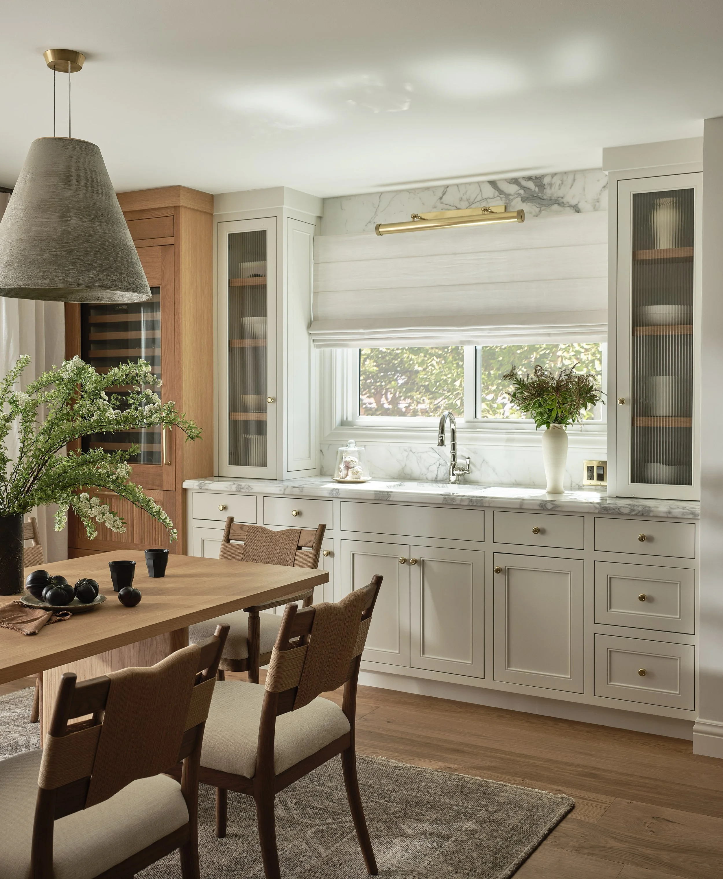 Custom built-in cabinetry and marble countertops highlight this dining area in this Addition & Full Home Remodel.