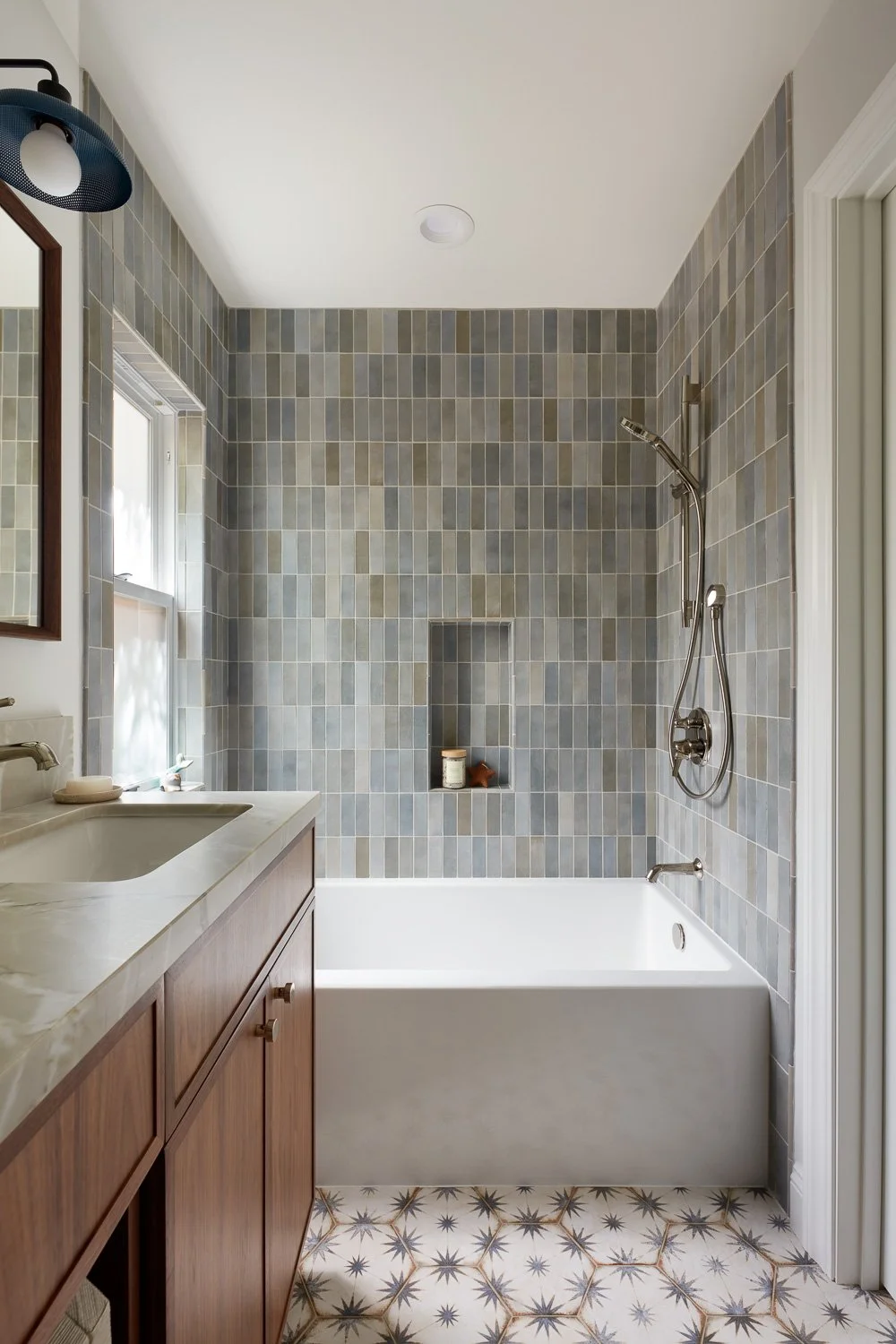 Elegant bathroom with wood cabinetry and marble counters – custom home remodel