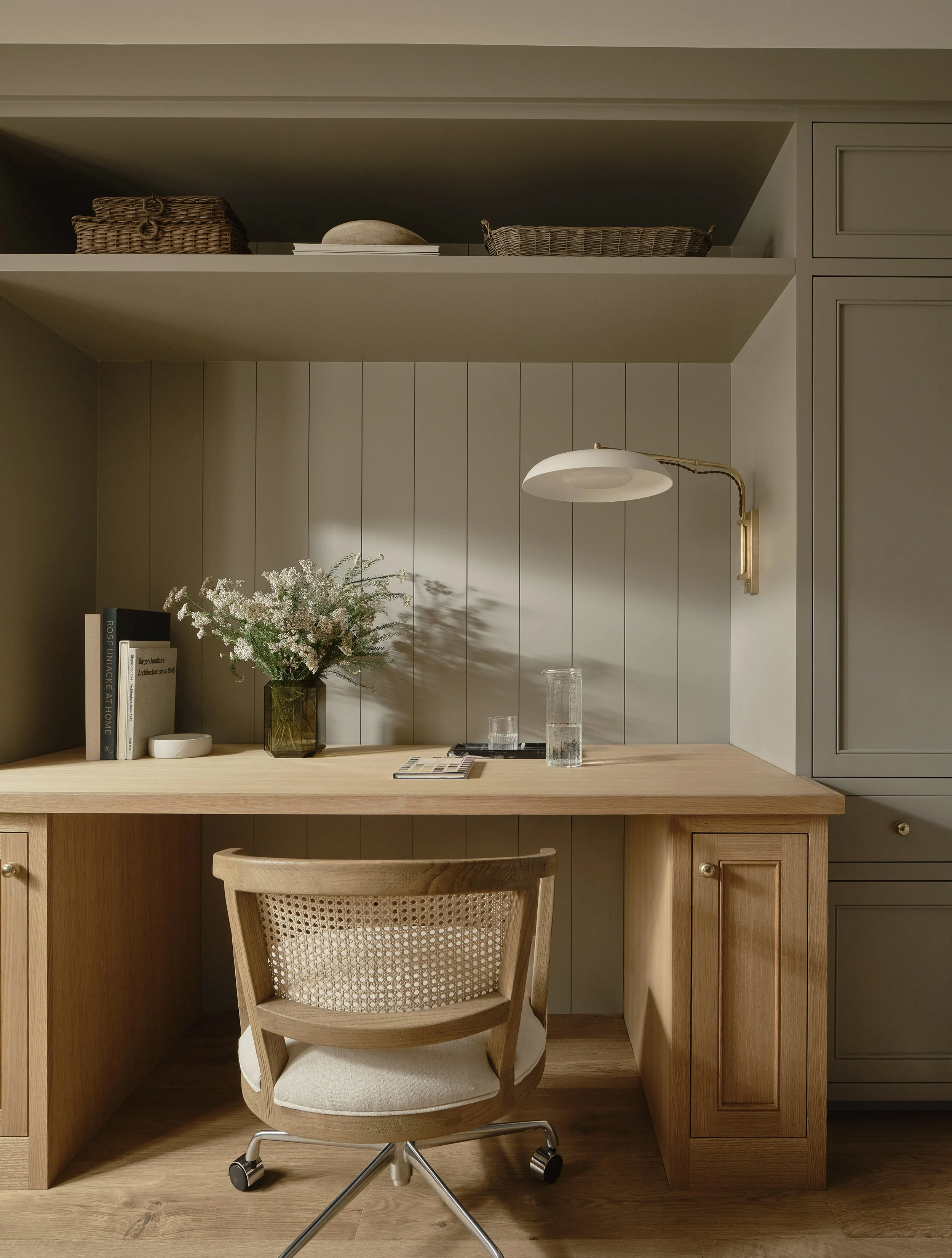 Functional home office with natural wood desk and tailored millwork in this Addition & Full Home Remodel.