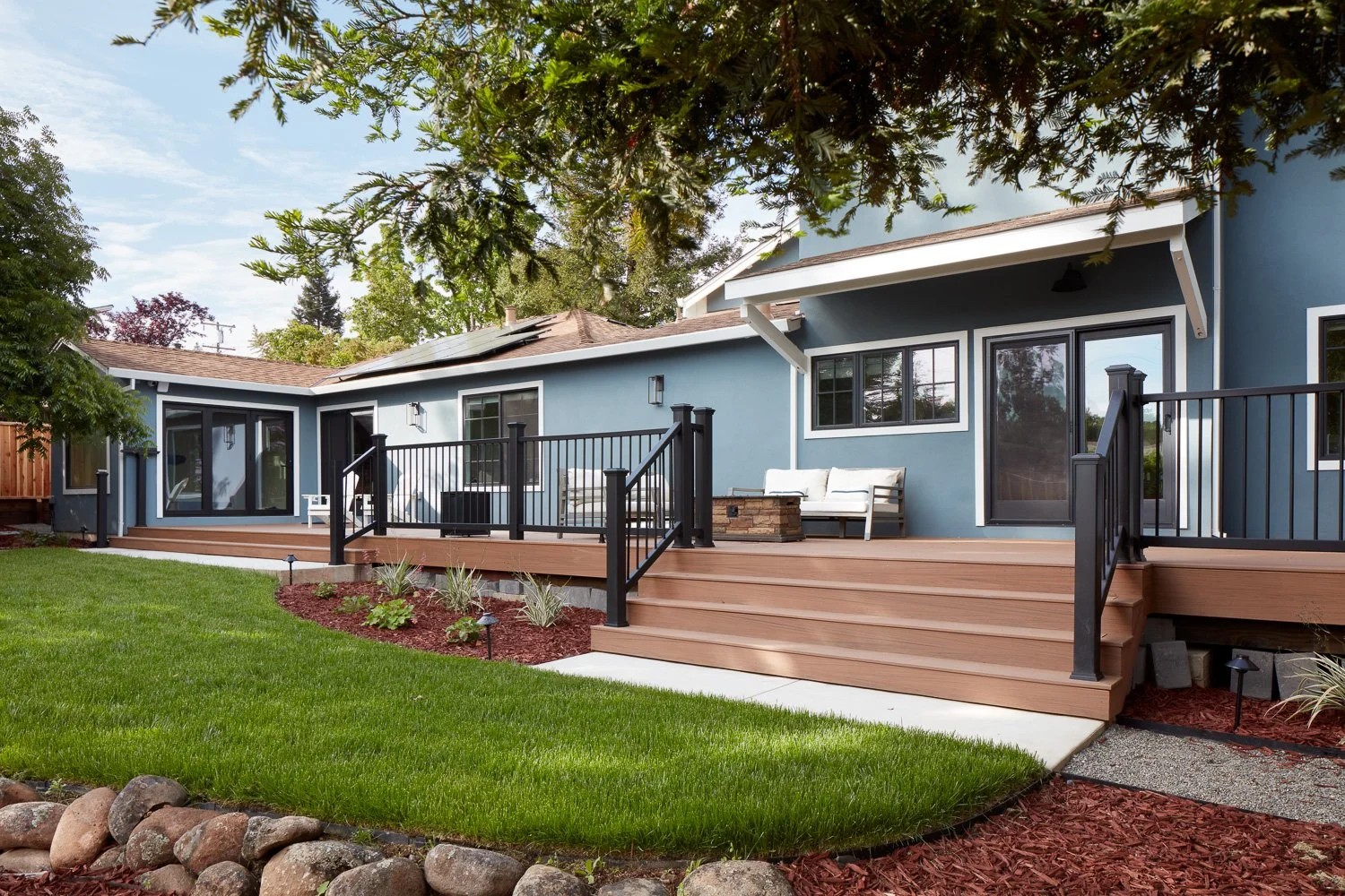 Spacious composite deck with clean lines and integrated seating – custom home remodel.