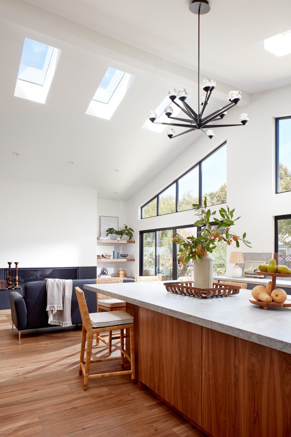 Skylights and large windows fill this open-concept space with light, defining the heart of this custom new construction home.