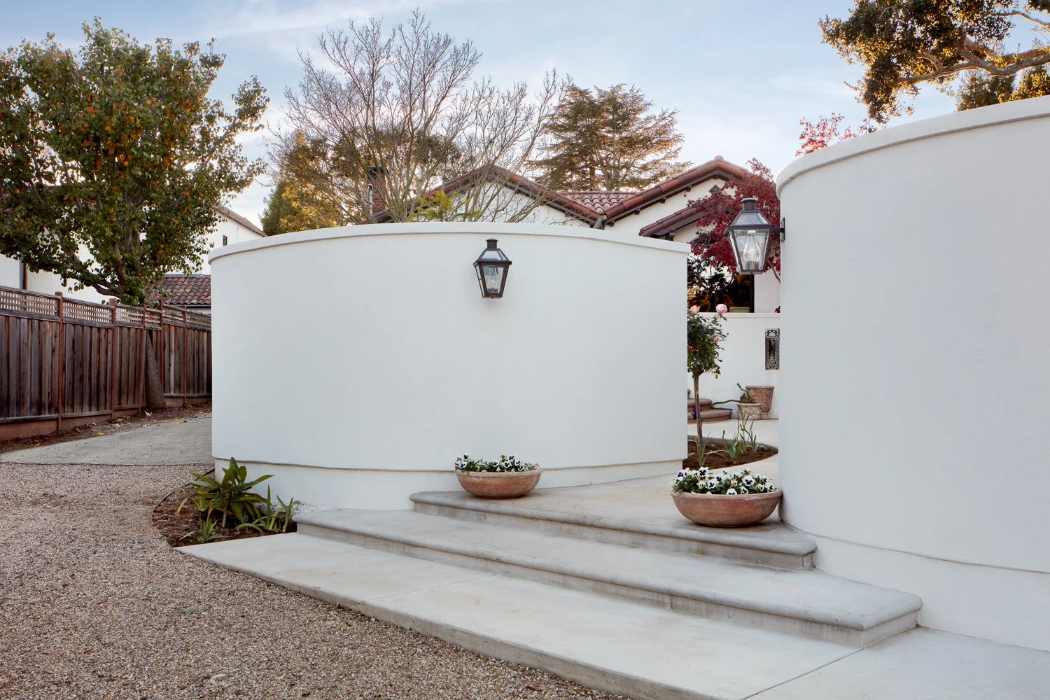 Elegant curved entry with smooth stucco walls and custom concrete steps, setting the tone for this luxury full home remodel in San Mateo.